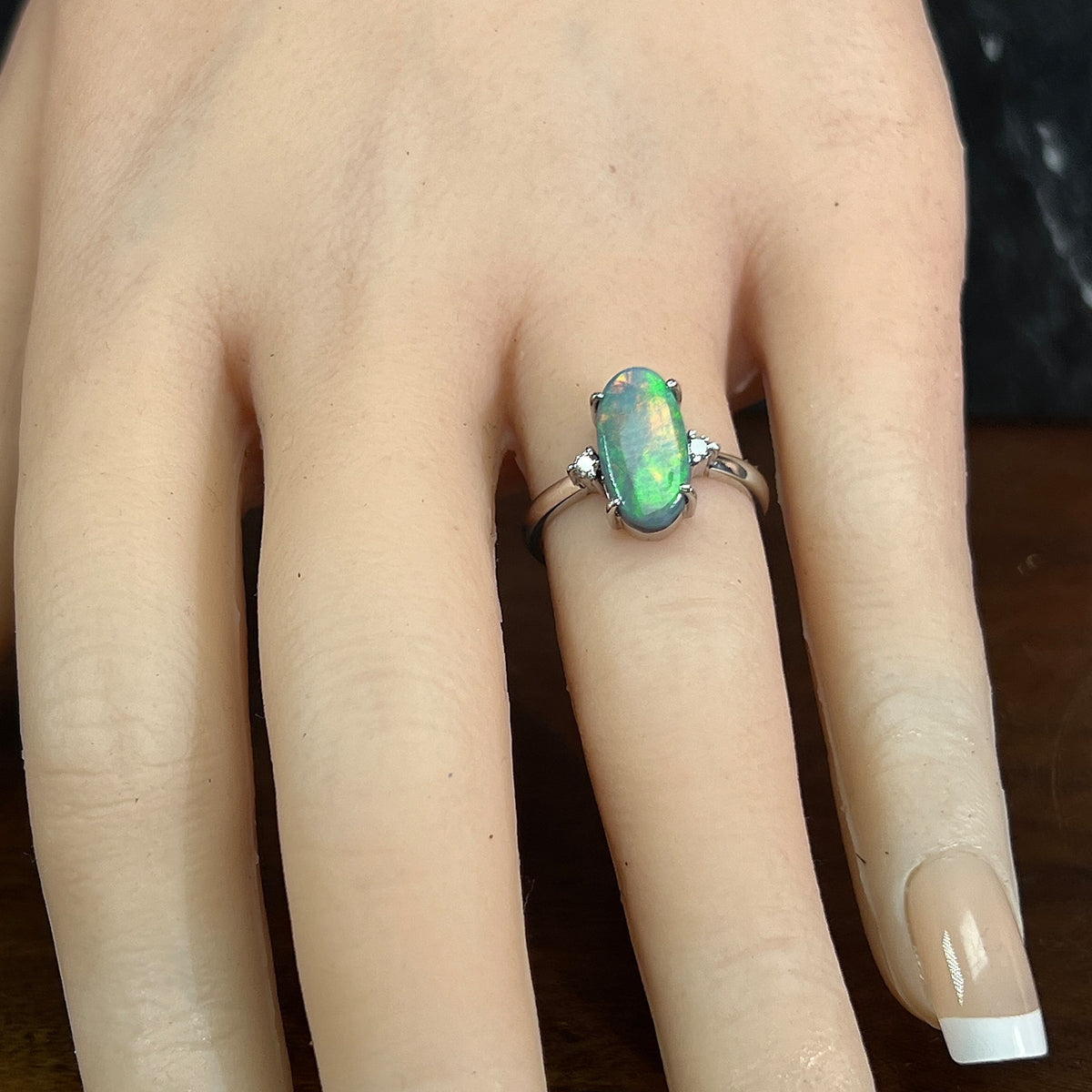 Australian black opal ring on the finger, 1.4ct oval black opal in 18kt white gold