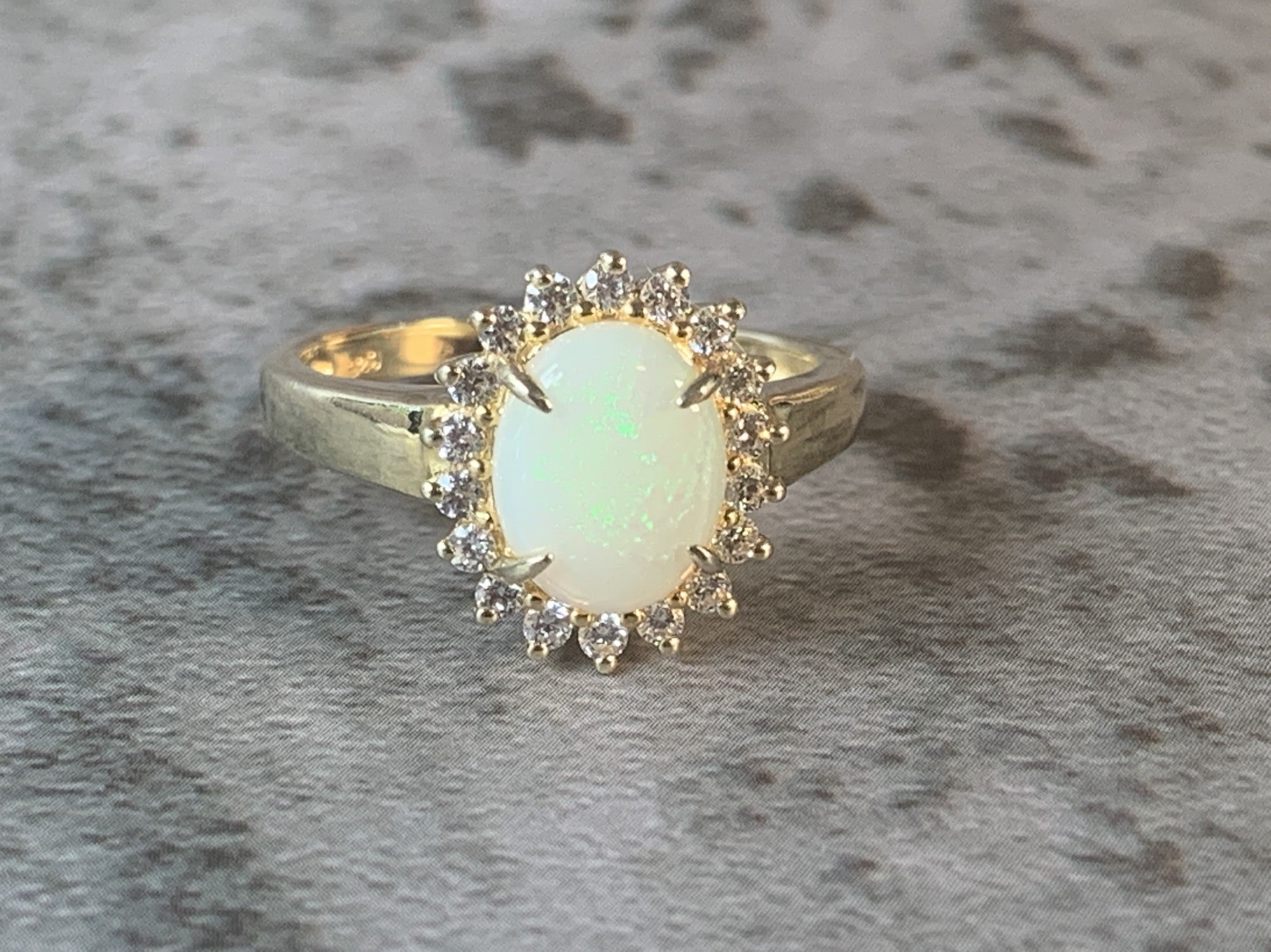 Gold Plated Silver 9x7mm White Opal and cubic zirconia Halo ring