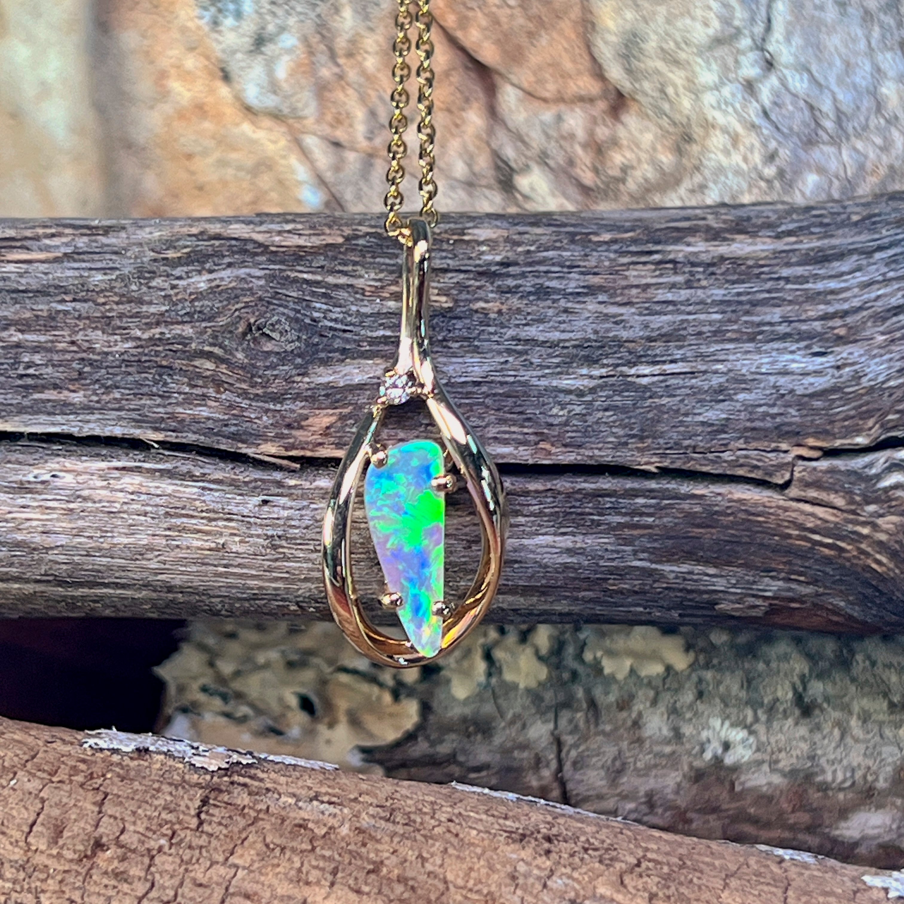 Triangular crystal opal pendant in 9kt yellow gold on a fine gold chain