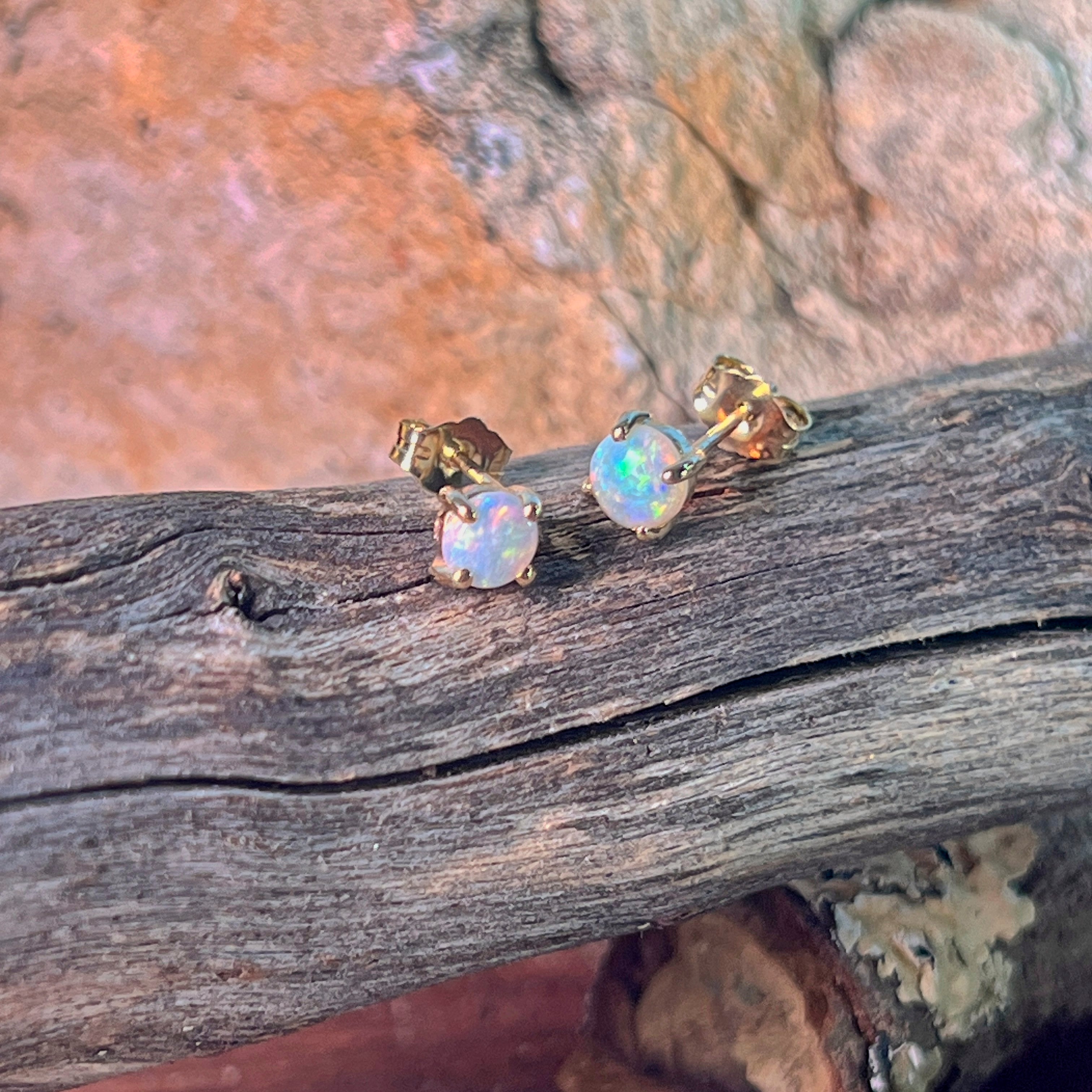 5.5mm round Australian crystal opals claw set in 9kt yellow gold studs