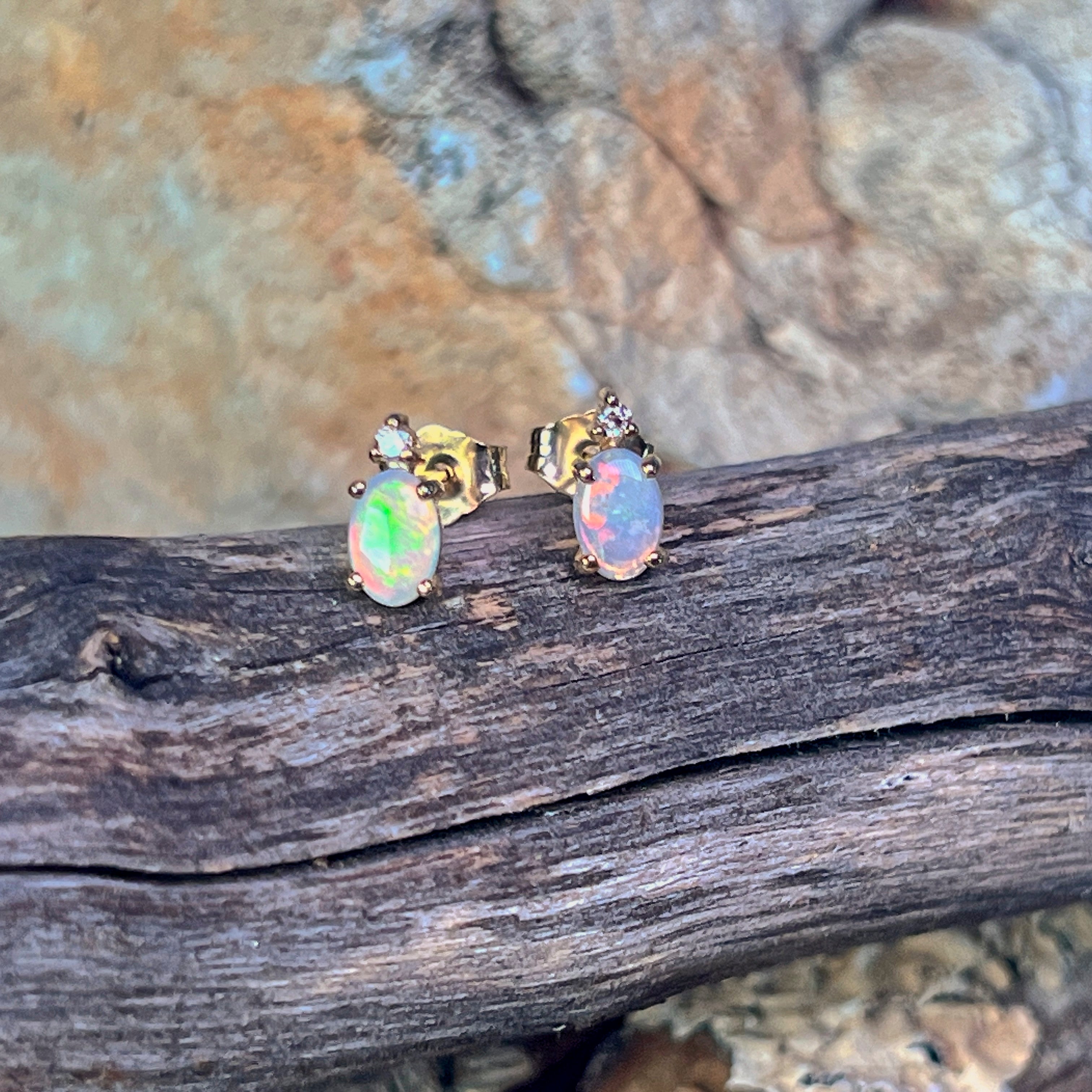 6x4mm oval Australian crystal opals with a diamond above each, in 9kt yellow gold