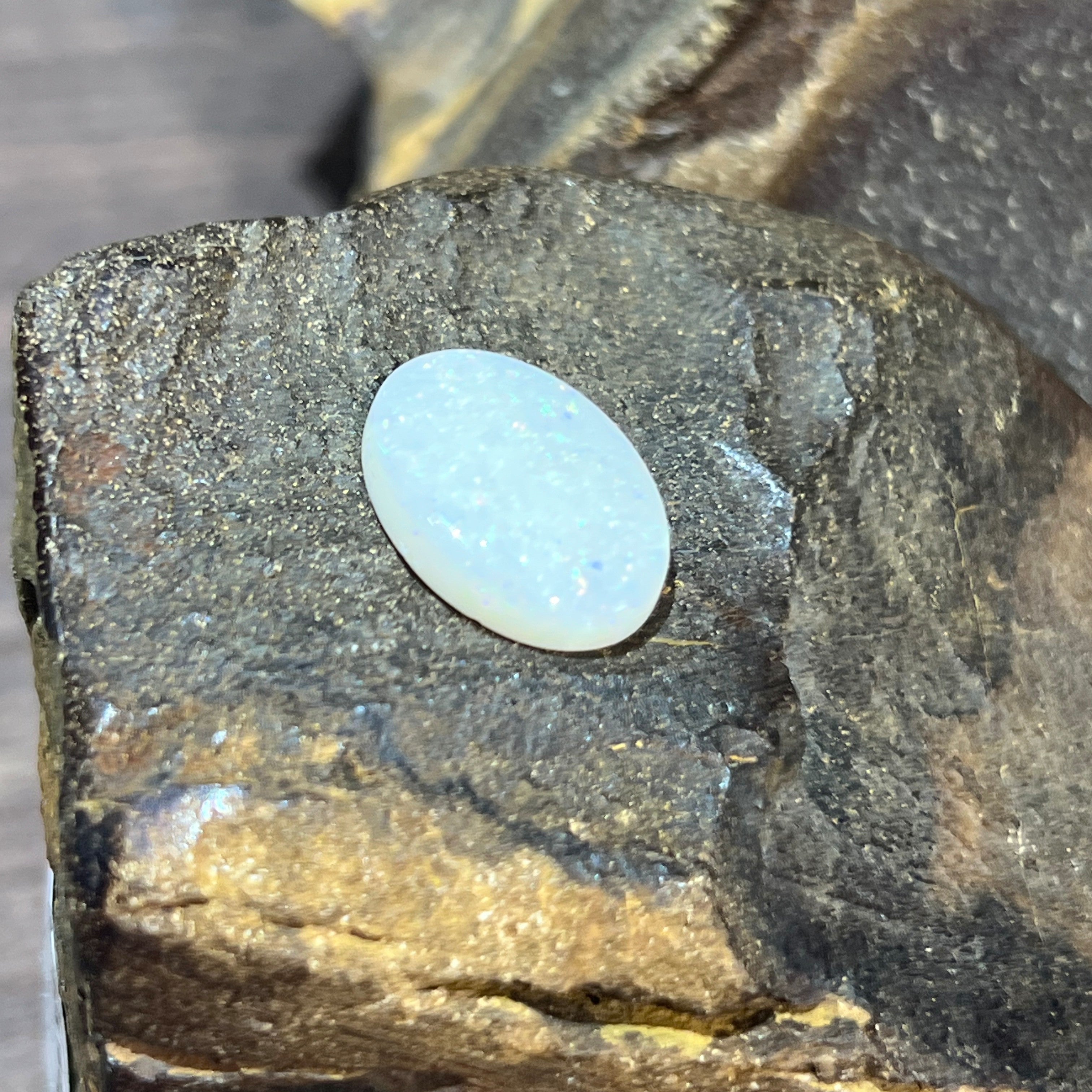 White opal 5.15ct with a smooth polished dome and subtle blue-white sheen