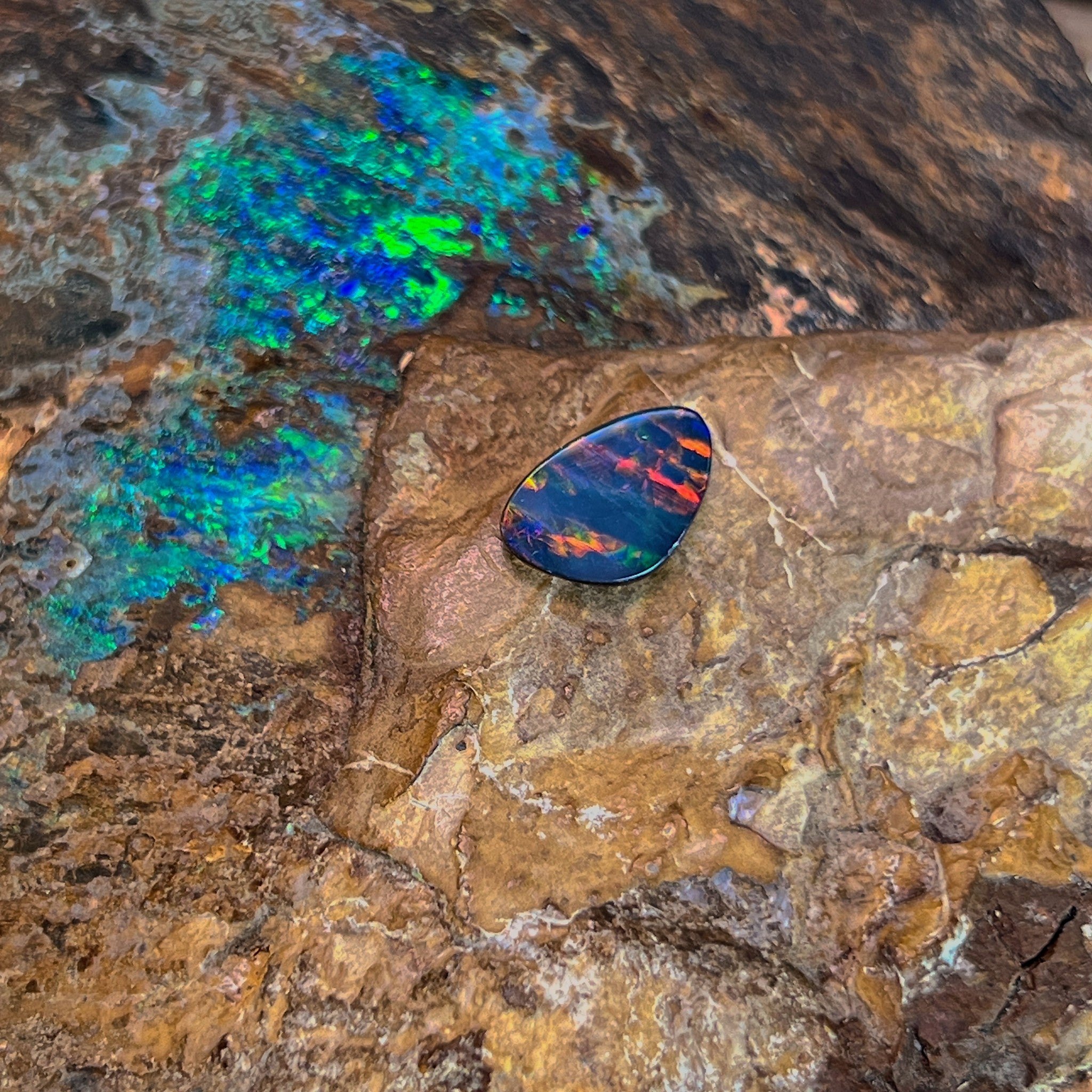 Banded orange and red flashes in a 1.5ct Australian opal doublet, 11.2x7.2mm, on ironstone