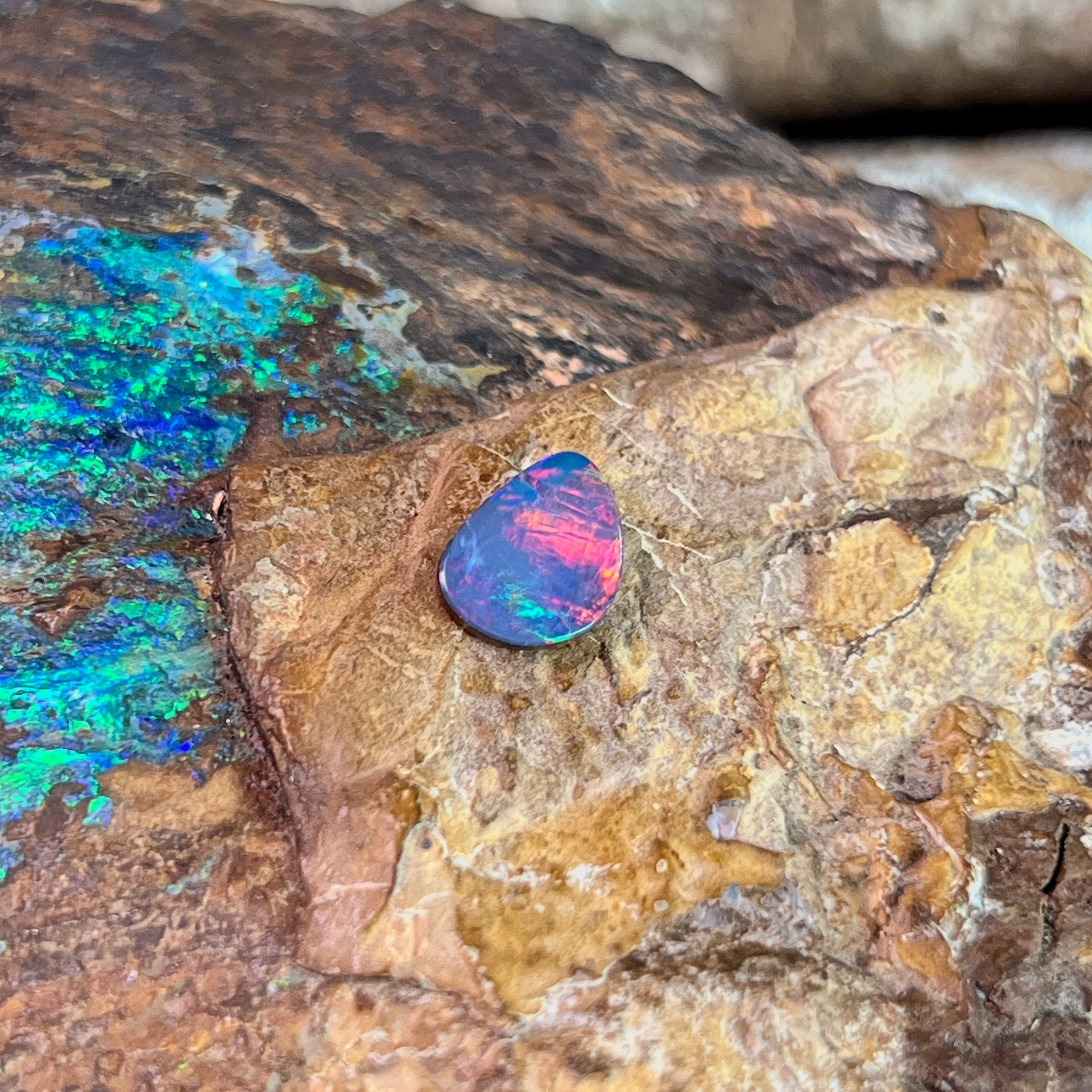 Magenta and blue-violet play-of-colour in a 1.47ct Australian opal doublet, 10x7.5mm