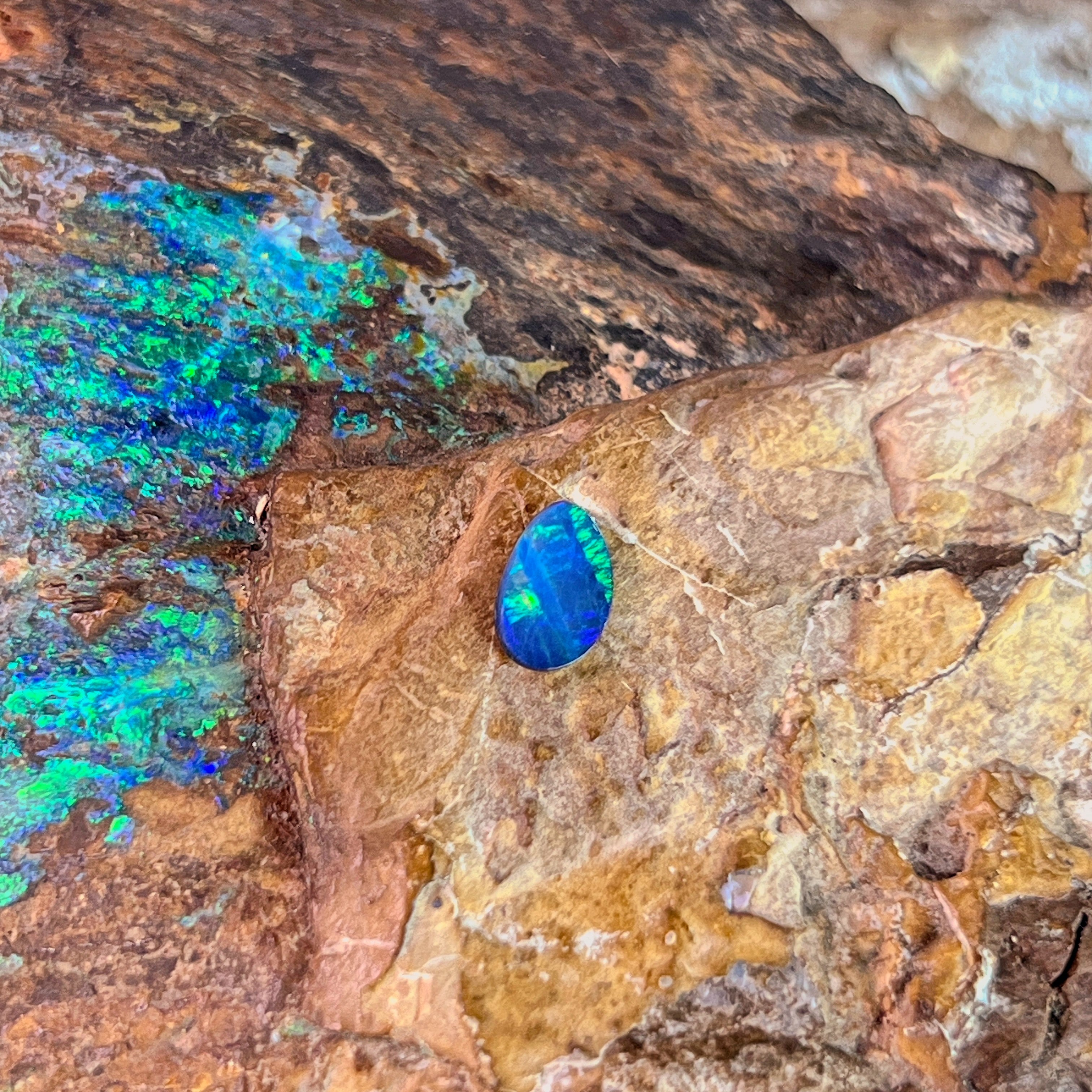 0.52ct Australian opal doublet on ironstone, a green flash across a blue violet body