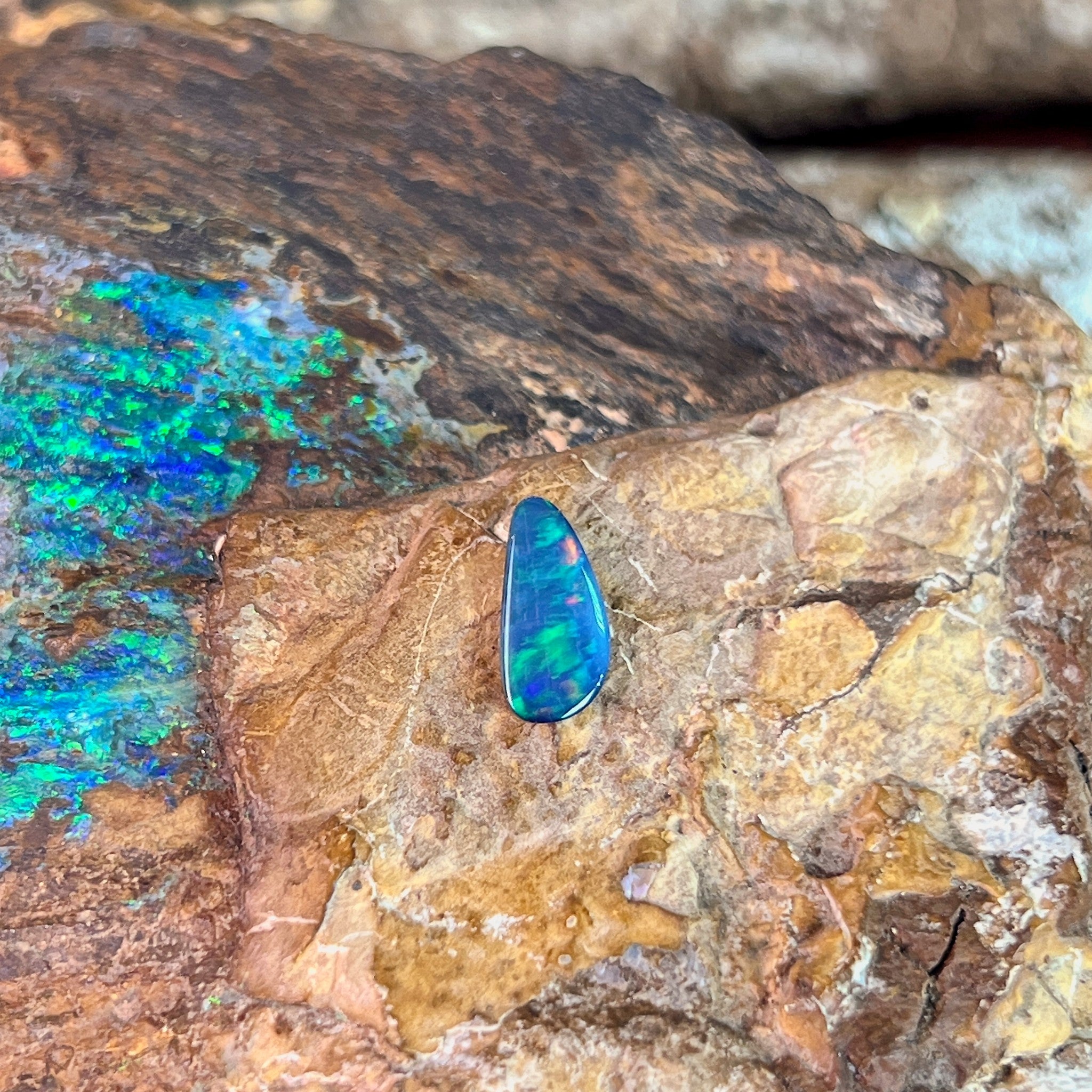 0.74ct Australian opal doublet on ironstone, green play-of-colour over a blue body