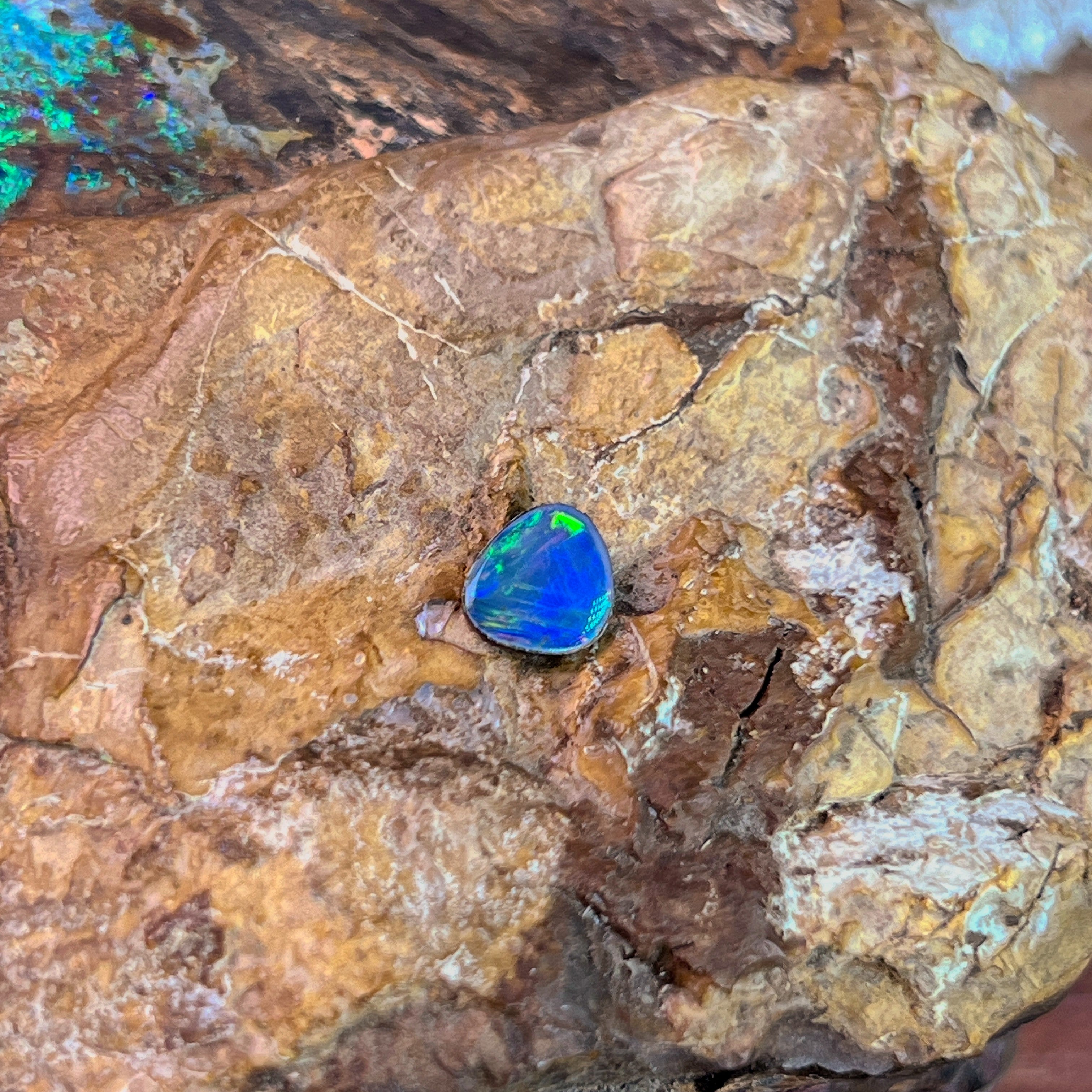 0.70ct Australian opal doublet on ironstone, a gold green flash along the upper edge