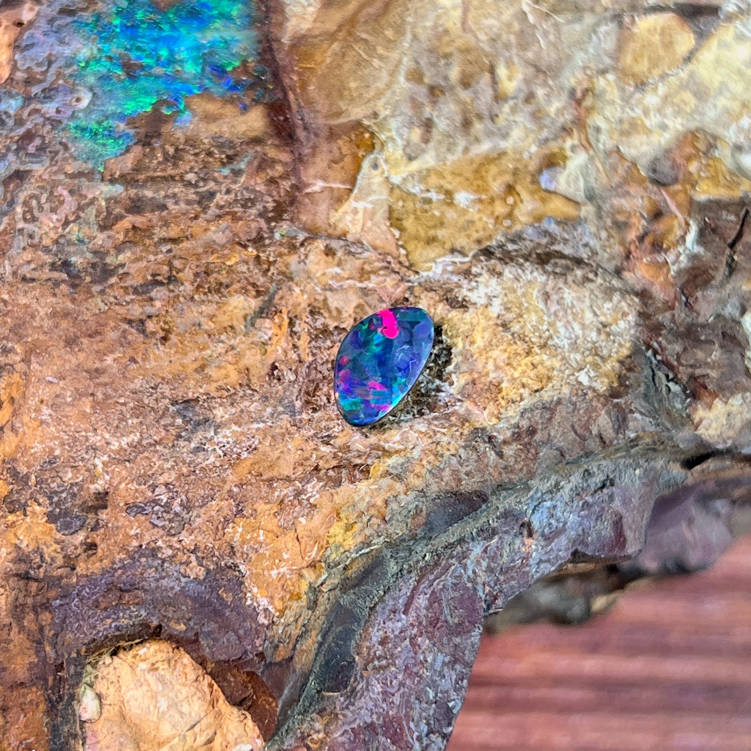 0.91ct Australian opal doublet on ironstone, magenta and green across a blue body