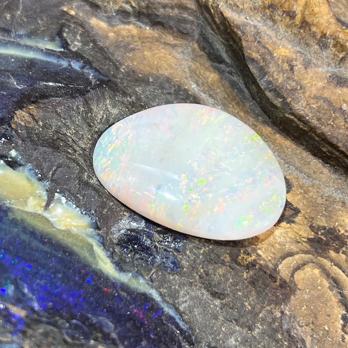 Loose solid white opal 14.70ct, freeform, yellow, orange and green play-of-colour, ready for a custom setting, on rock