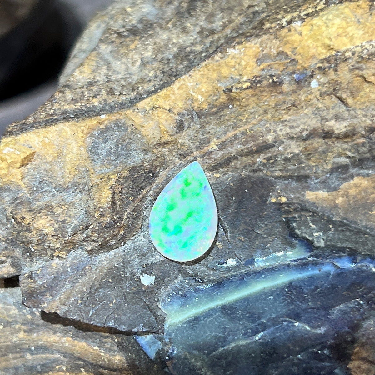 Solid Australian crystal opal 1.15ct, pear 11.8x7.8mm, green and yellow play-of-colour, loose stone on rock