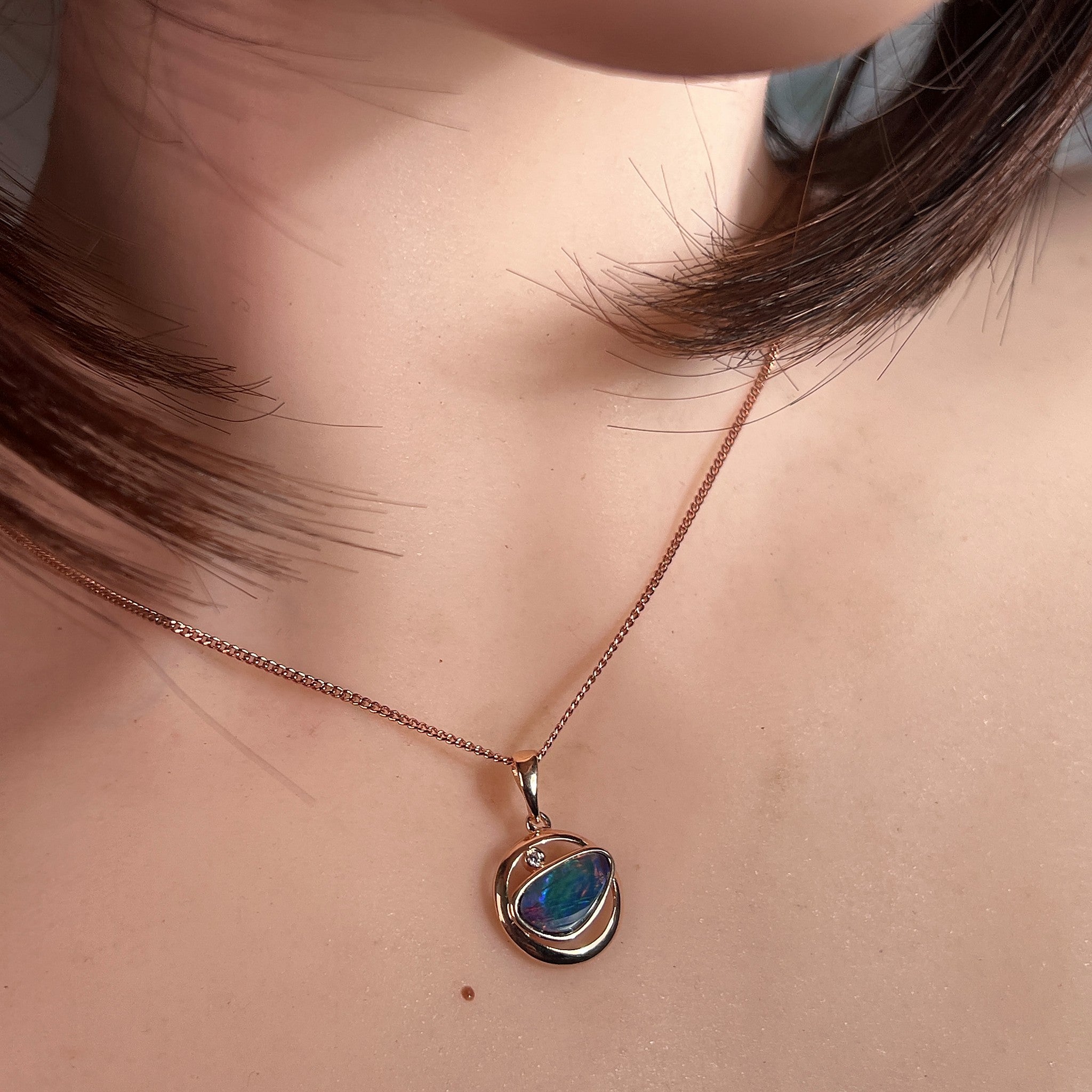 Worn Australian opal doublet pendant in rose gold-plated silver, blue, yellow, green and red, 12 x 11mm