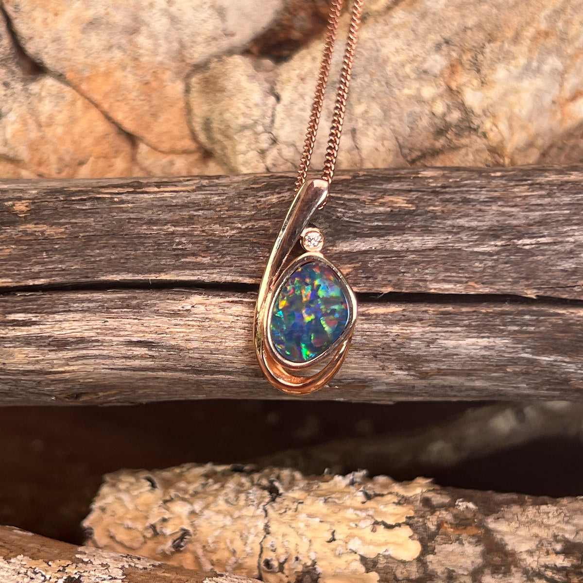 freeform Australian opal doublet pendant in rose gold-plated silver, green, red and blue play-of-colour