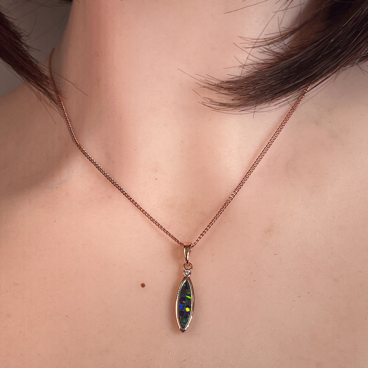 15 x 5mm marquise Australian opal doublet pendant worn at the neck, rose gold-plated silver