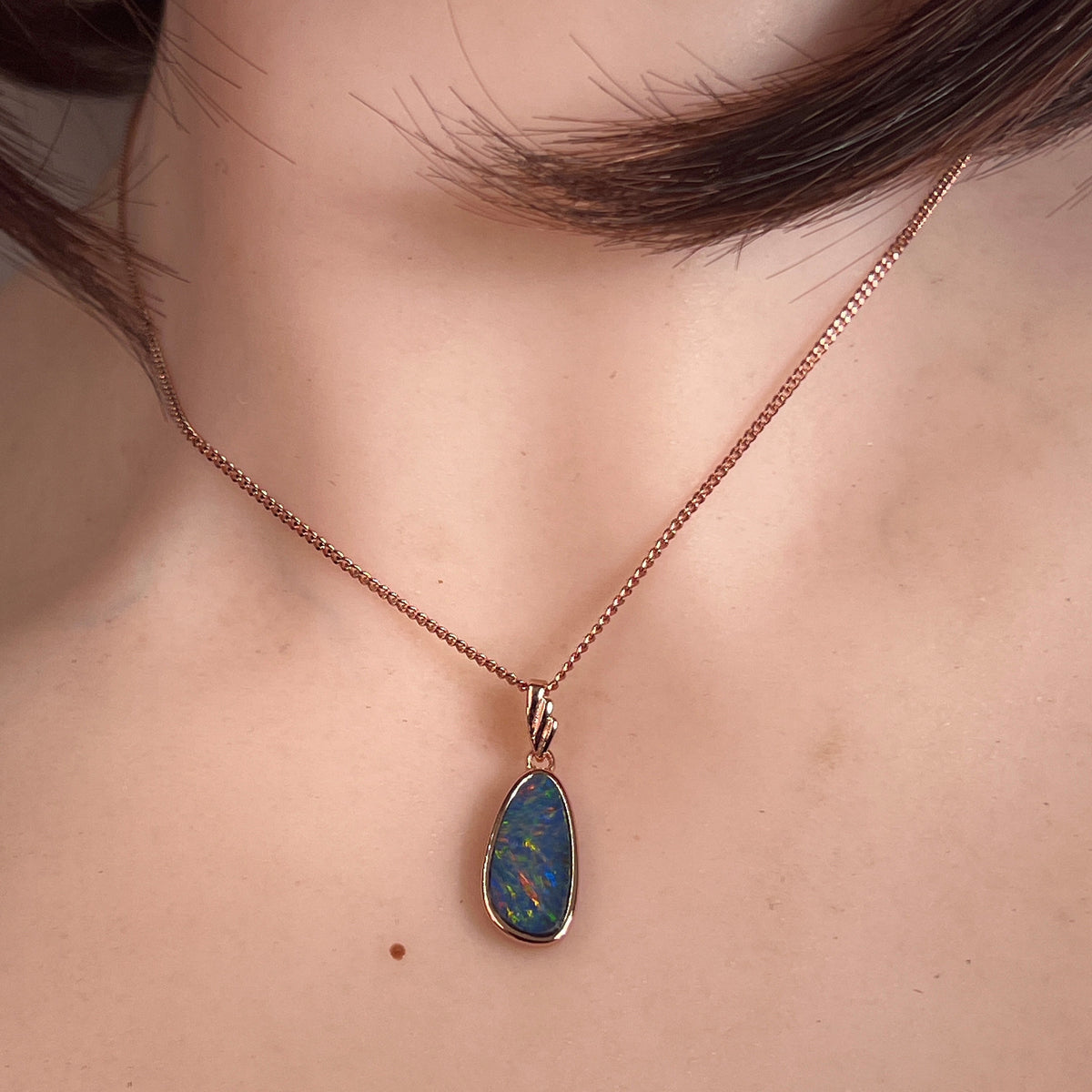 marquise Australian opal doublet pendant worn, rose gold-plated silver, red, blue, green and violet