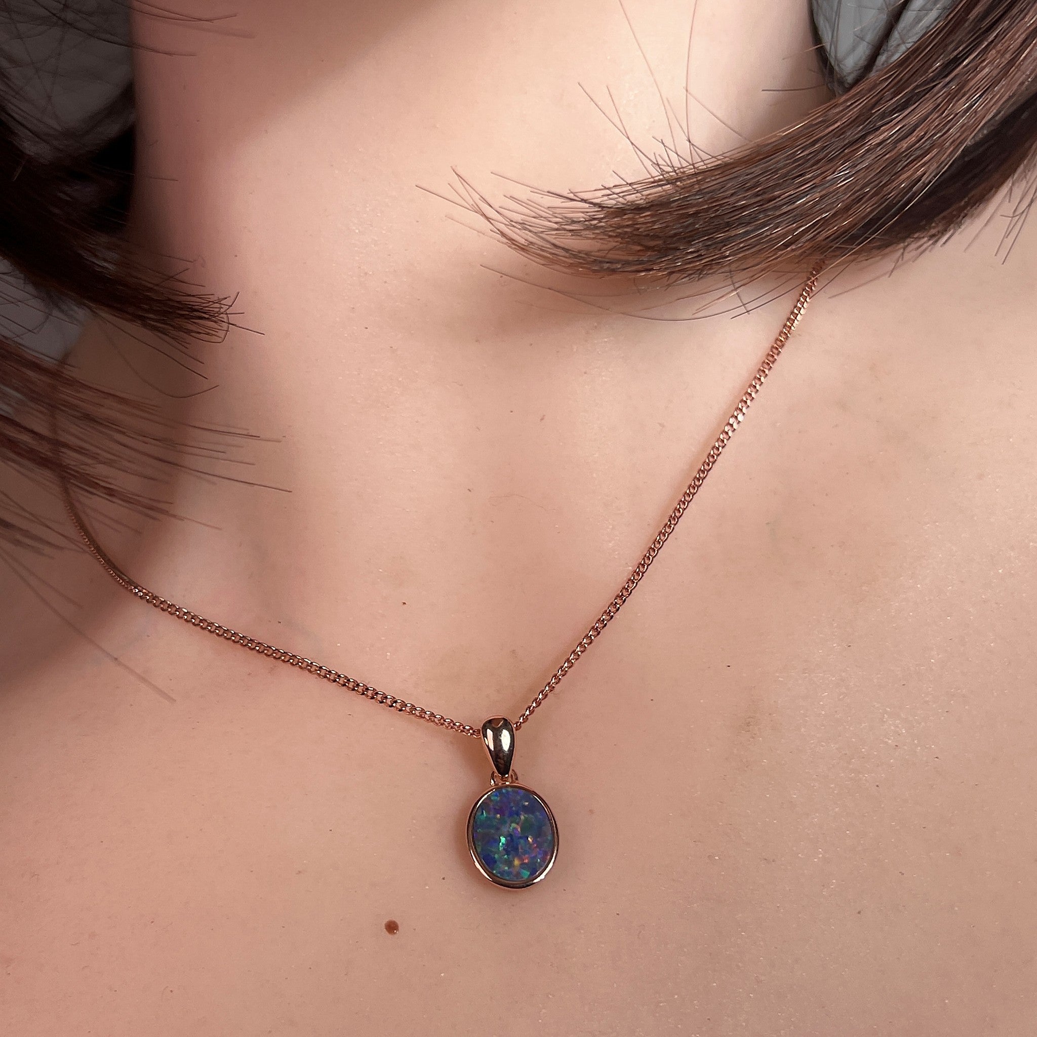 Australian opal doublet pendant worn at the neck, rose gold-plated silver, 10 x 8mm oval stone