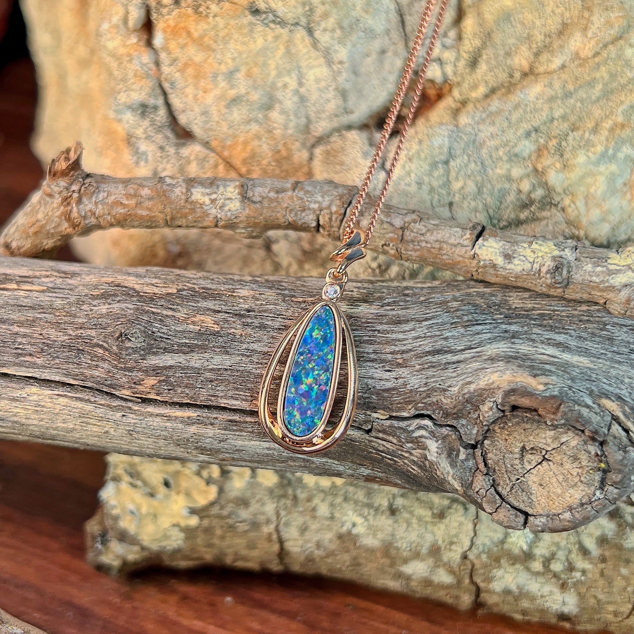 blue, yellow, green and red play-of-colour in a 16.5 x 5.5mm pear-shaped Australian opal doublet pendant