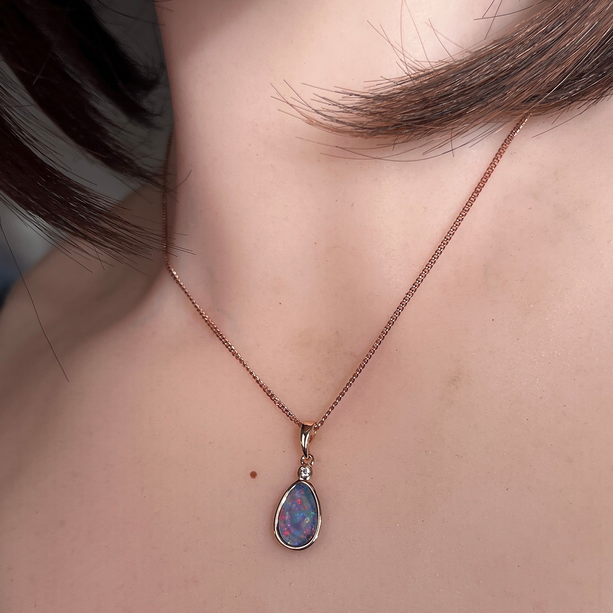 Worn Australian opal doublet pendant in rose gold-plated silver, blue, red, yellow and green, 11 x 7mm