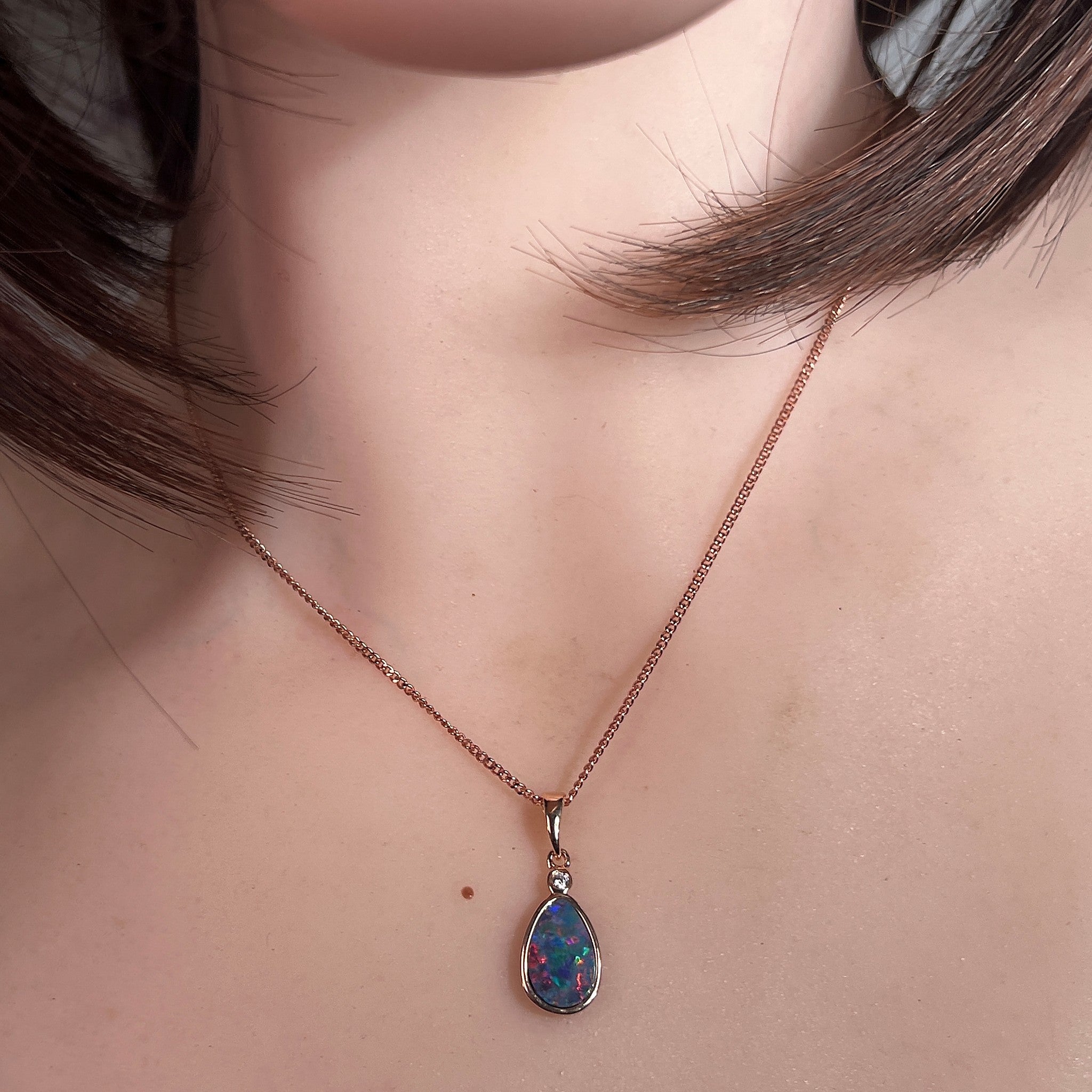 Australian opal doublet pendant worn at the neck, rose gold-plated silver, 11 x 7mm pear-shaped stone