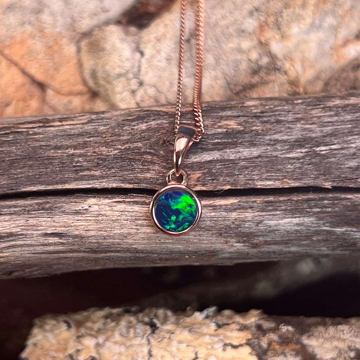 round Australian opal doublet pendant in rose gold-plated silver, green, red and blue play-of-colour