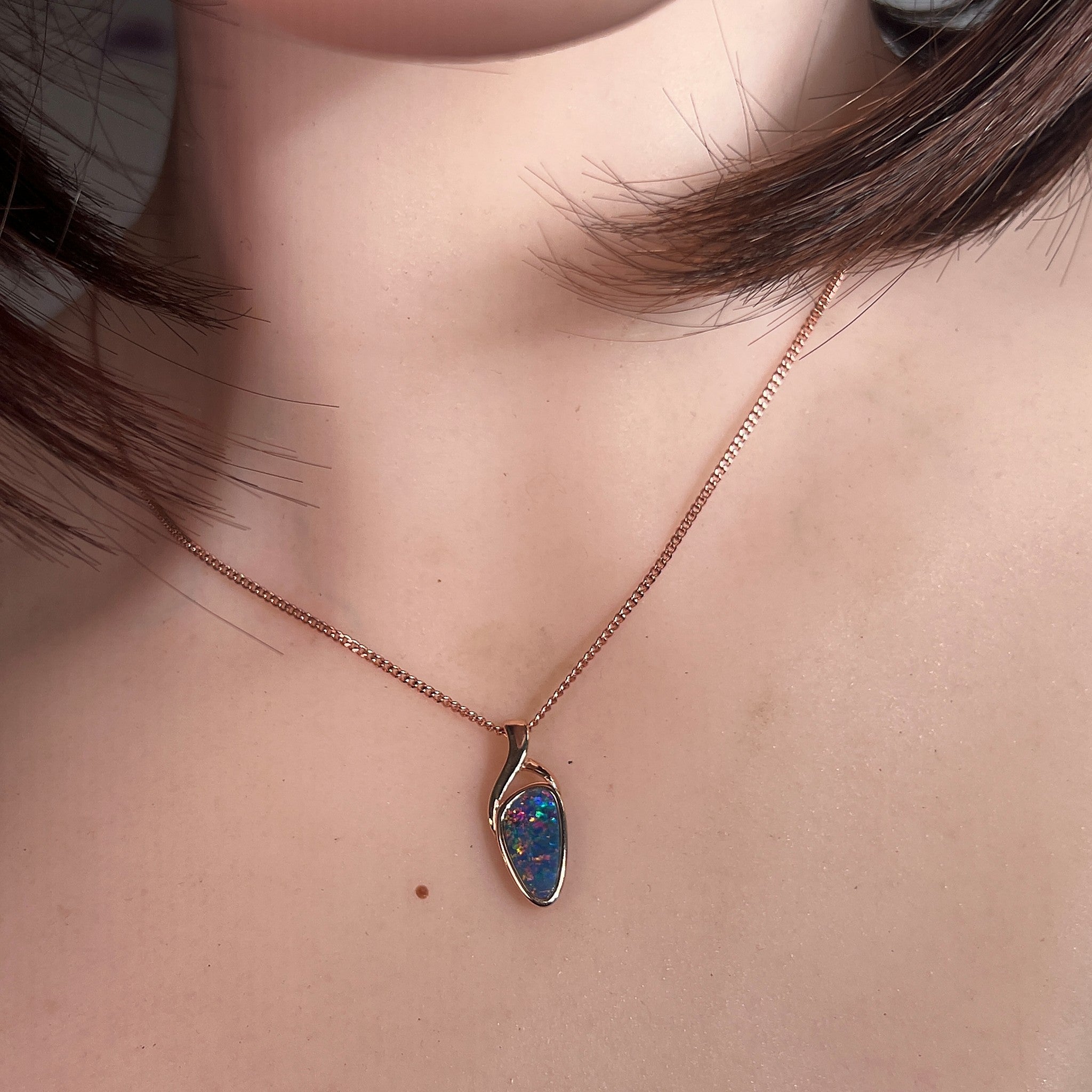 triangular Australian opal doublet pendant in rose gold-plated silver, worn at the neck