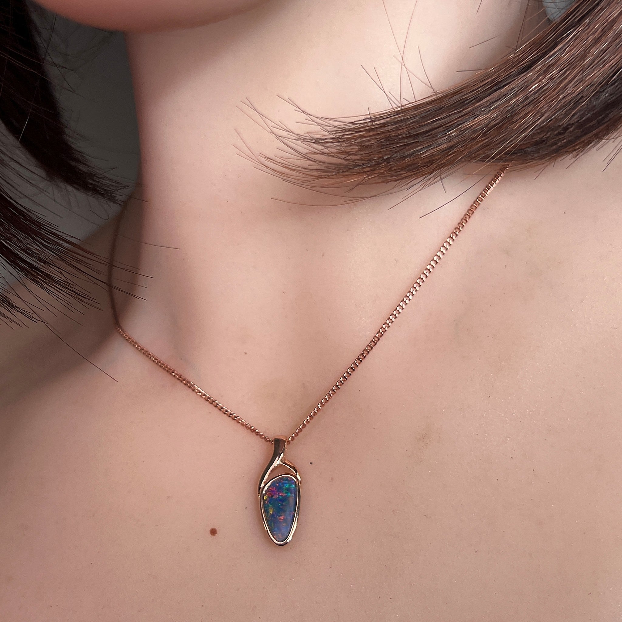 Worn Australian opal doublet pendant in rose gold-plated silver, blue, yellow, green and red, 11 x 5.5mm