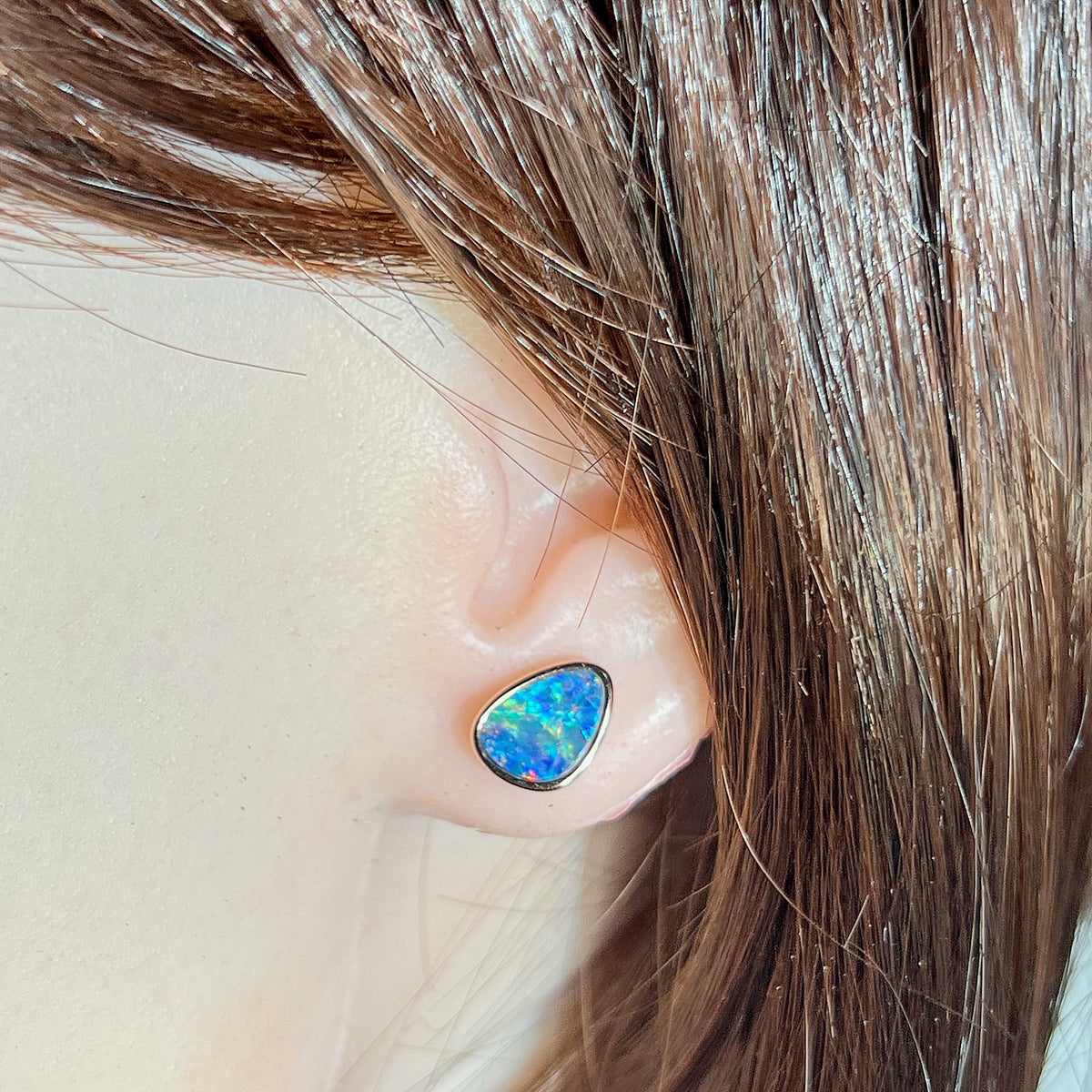Worn Australian opal doublet earrings in rose gold-plated silver, red, blue and green, 10 x 8mm