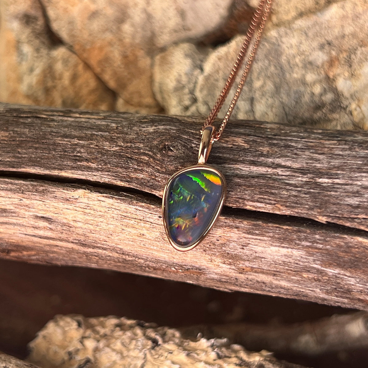 12 x 8mm freeform Australian opal triplet, bezel set in rose gold-plated silver, red, green and blue