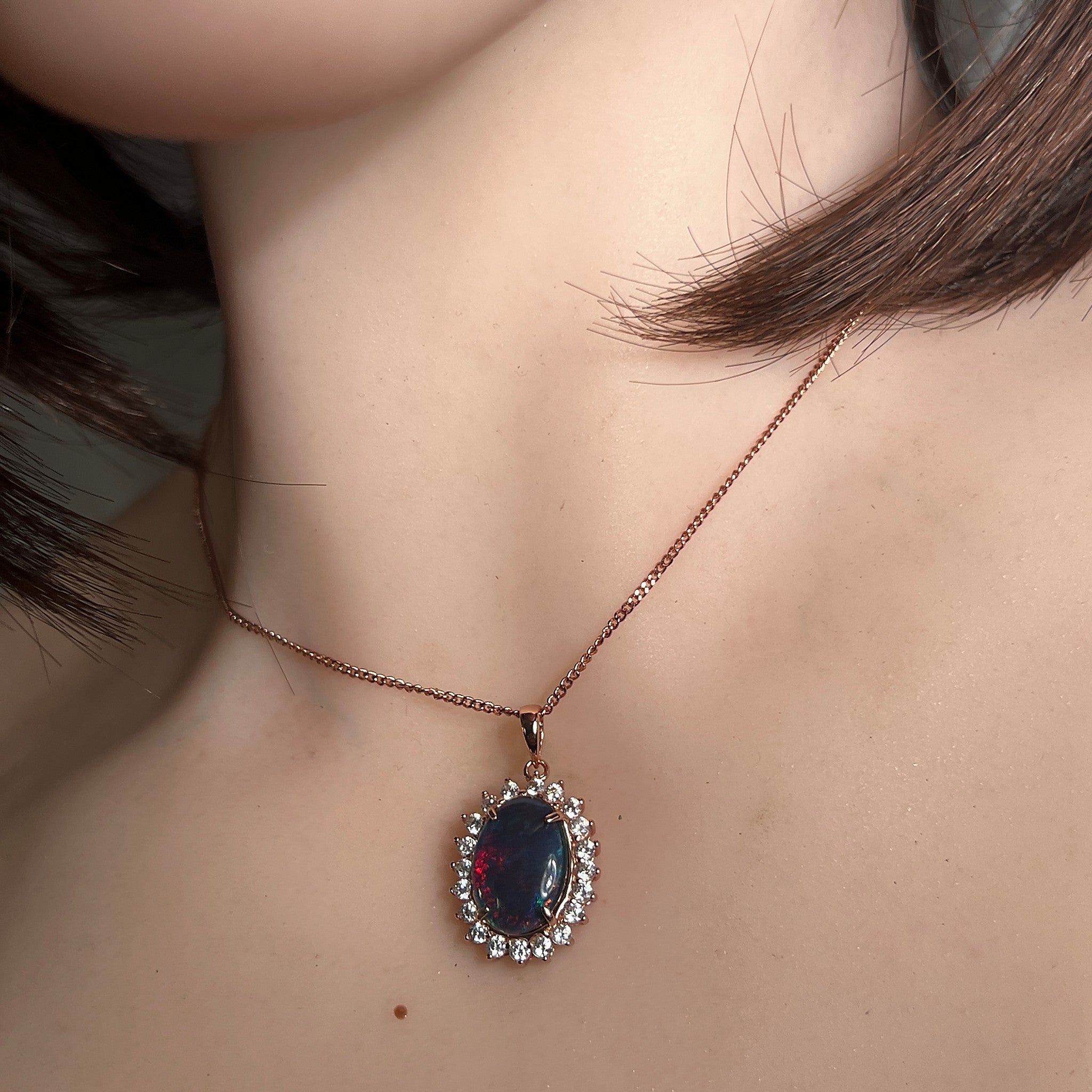oval Australian opal triplet pendant and earring set worn, rose gold-plated silver, red, blue and green
