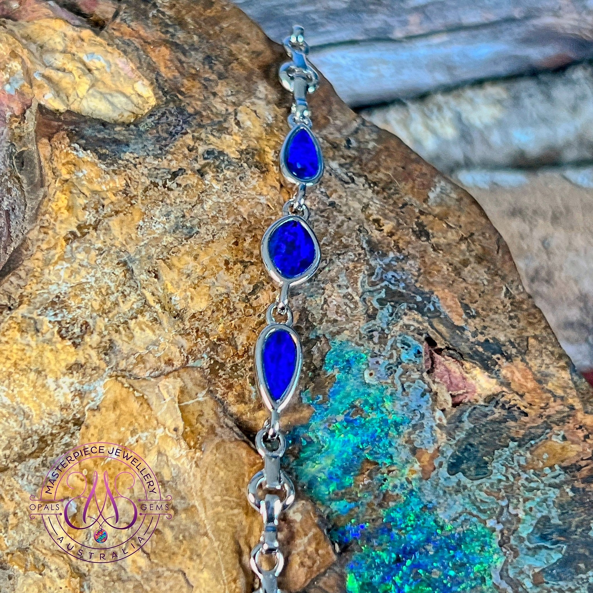 Close view of the blue and black play of colour in the freeform opal doublets