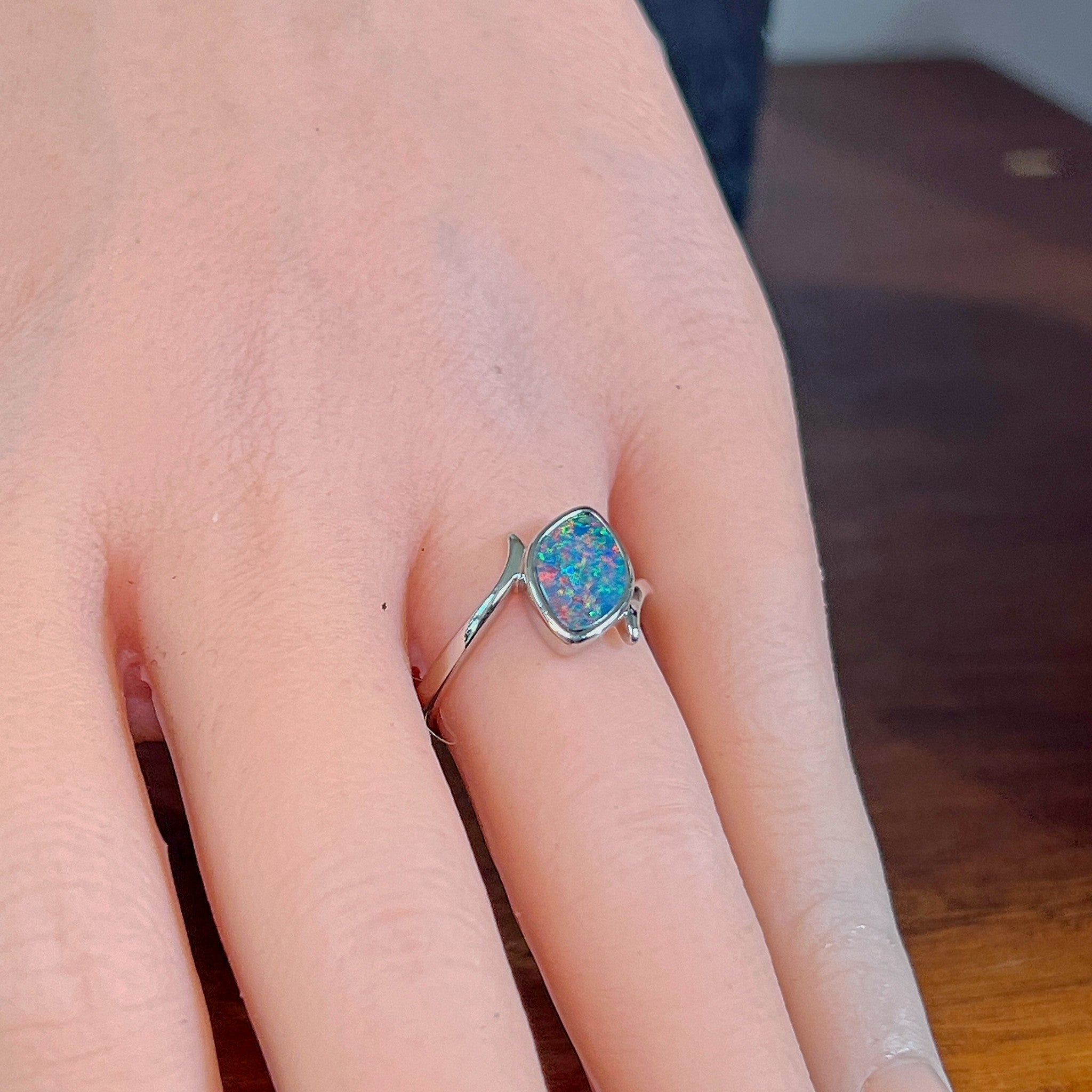 Marquise opal doublet ring in silver worn on the hand, showing its scale on the finger