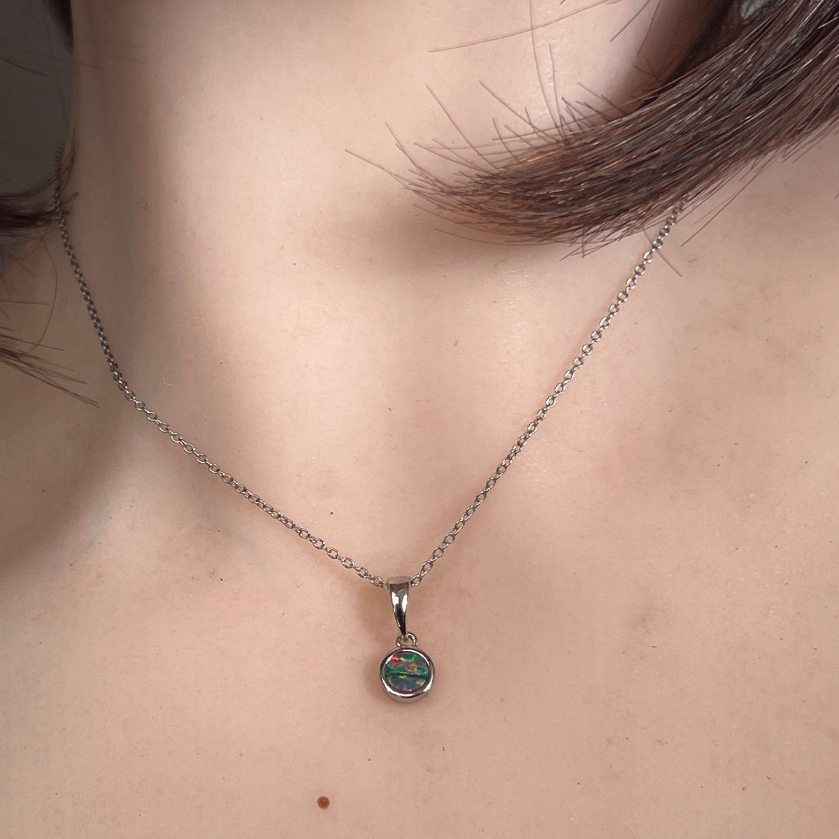 Worn Australian opal doublet pendant in sterling silver, red, blue and green, 5mm