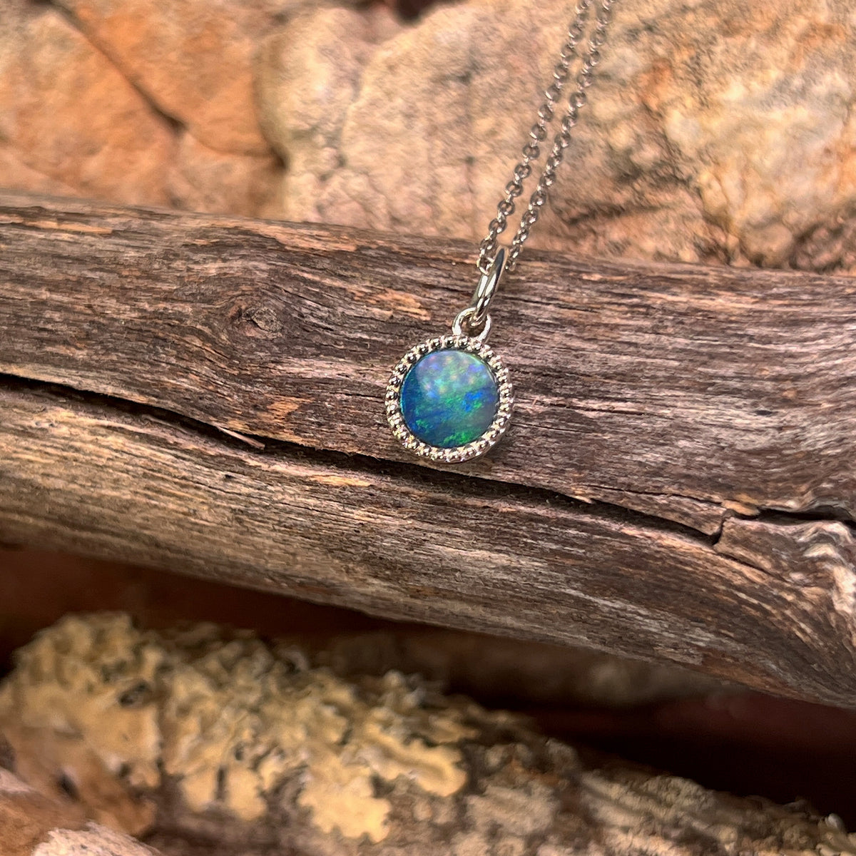 sterling silver Australian opal doublet pendant with a 7mm round stone