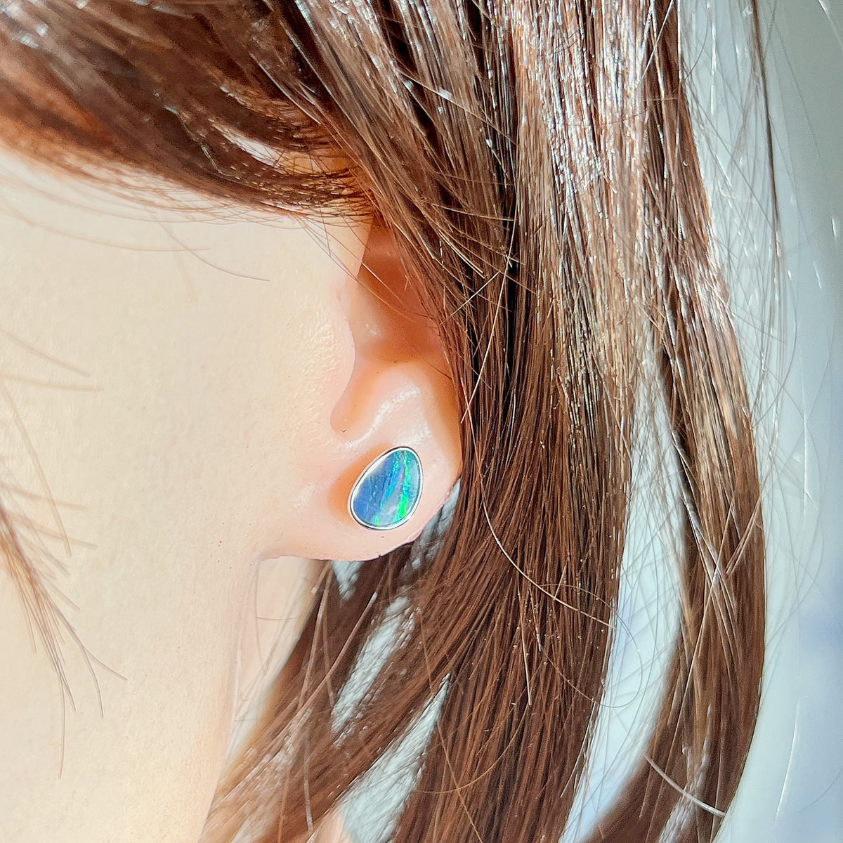 10 x 7mm triangular Australian opal doublet earrings worn on the ear, sterling silver