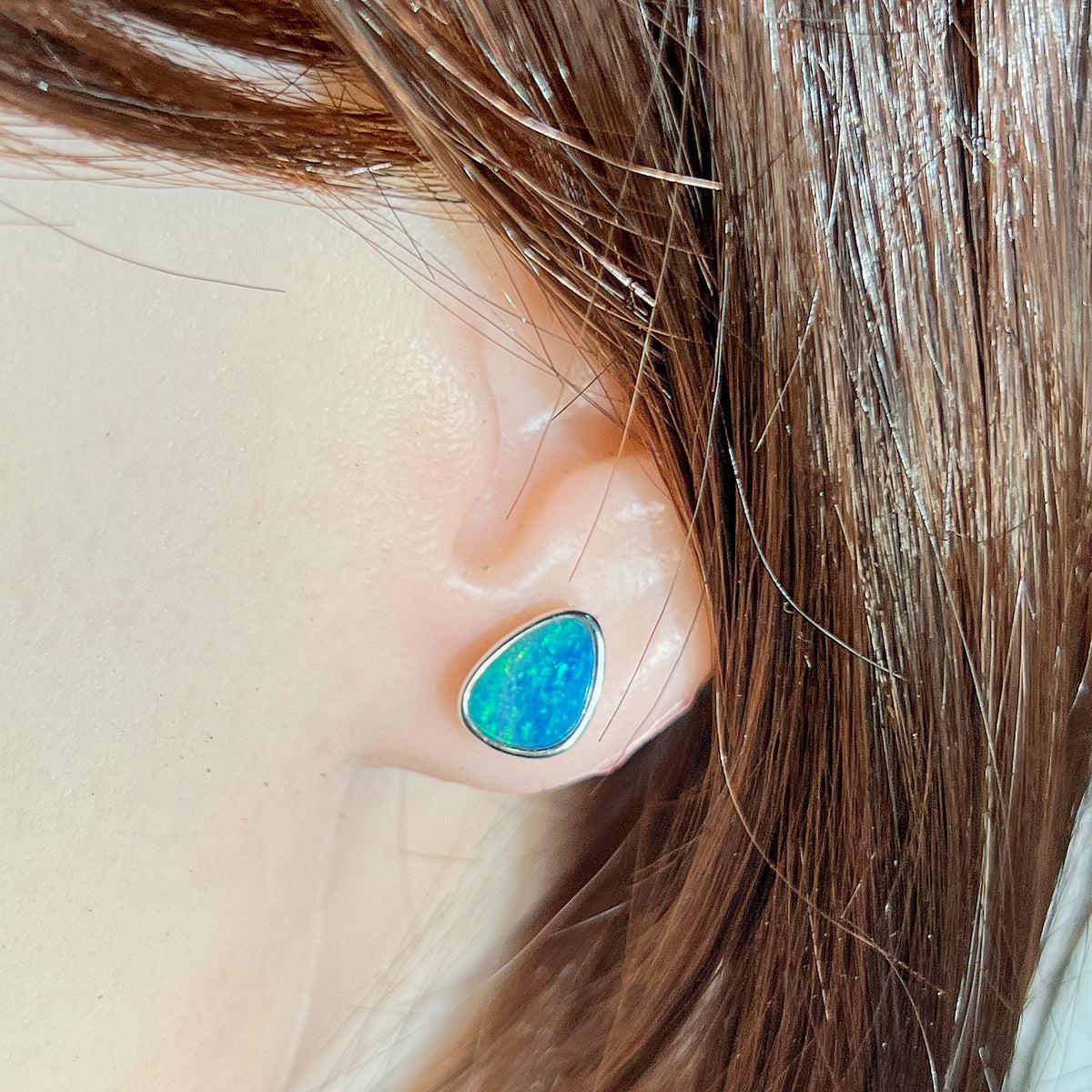 10 x 8mm triangular Australian opal doublet earrings worn on the ear, sterling silver