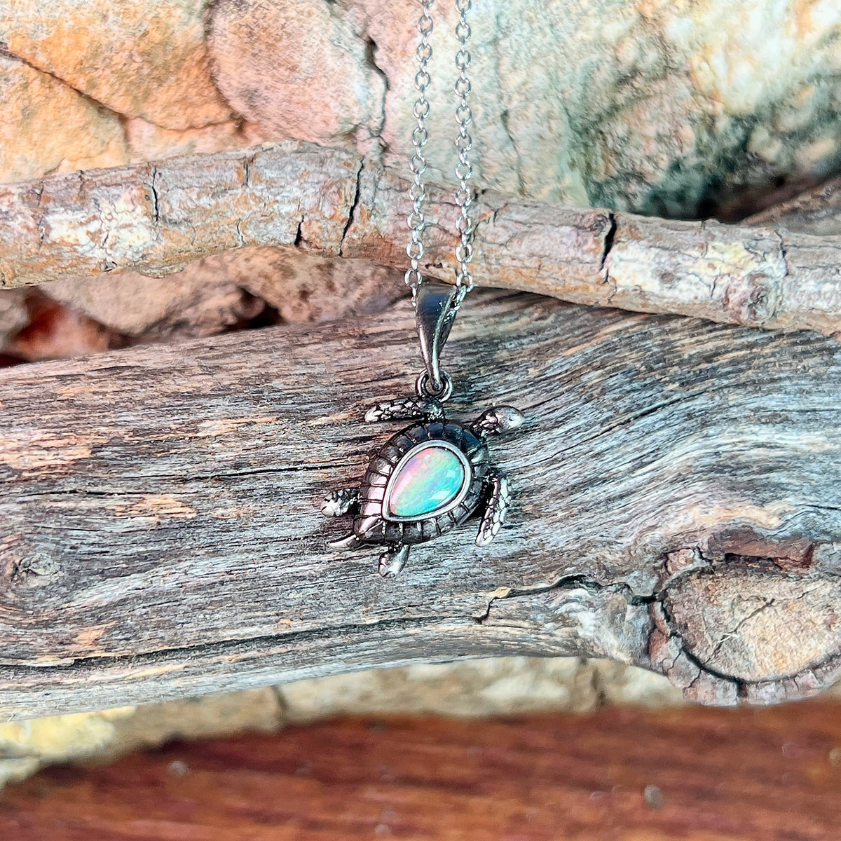 pear-shaped Australian crystal opal pendant in sterling silver, red, green, blue and pink play-of-colour