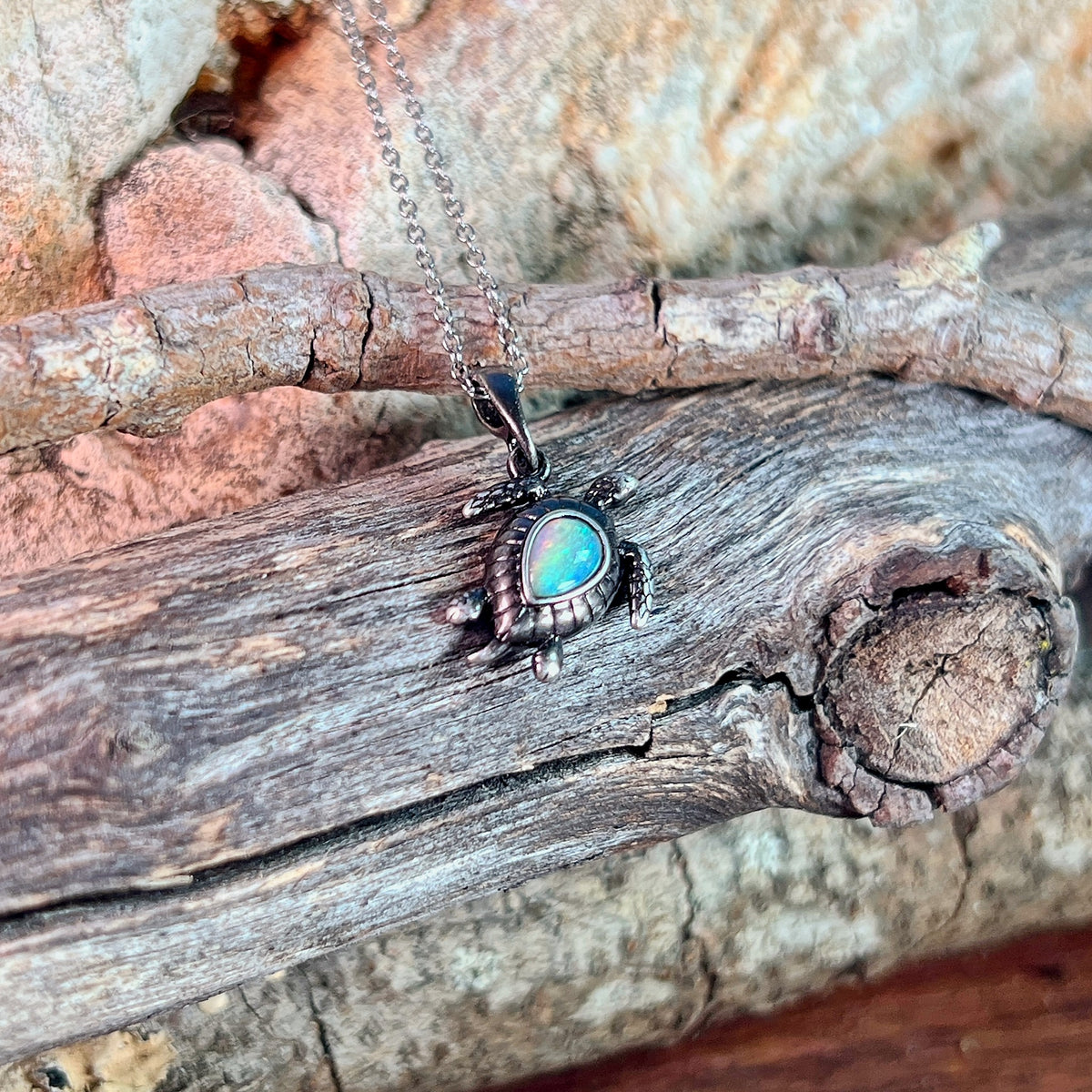 red, green, blue and pink play-of-colour in a 7 x 5mm pear-shaped Australian crystal opal pendant