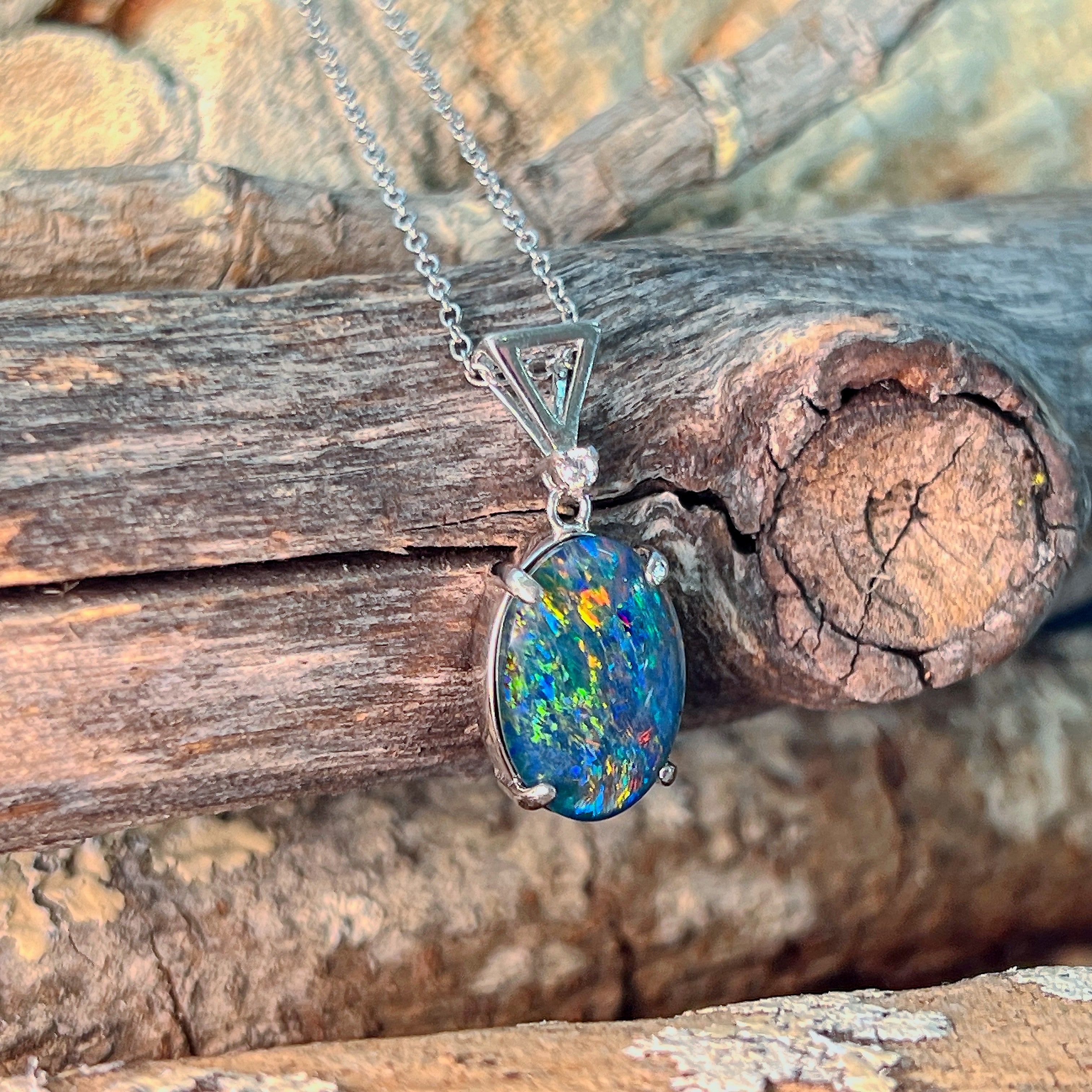 Oval opal triplet pendant in silver showing green and gold play-of-colour