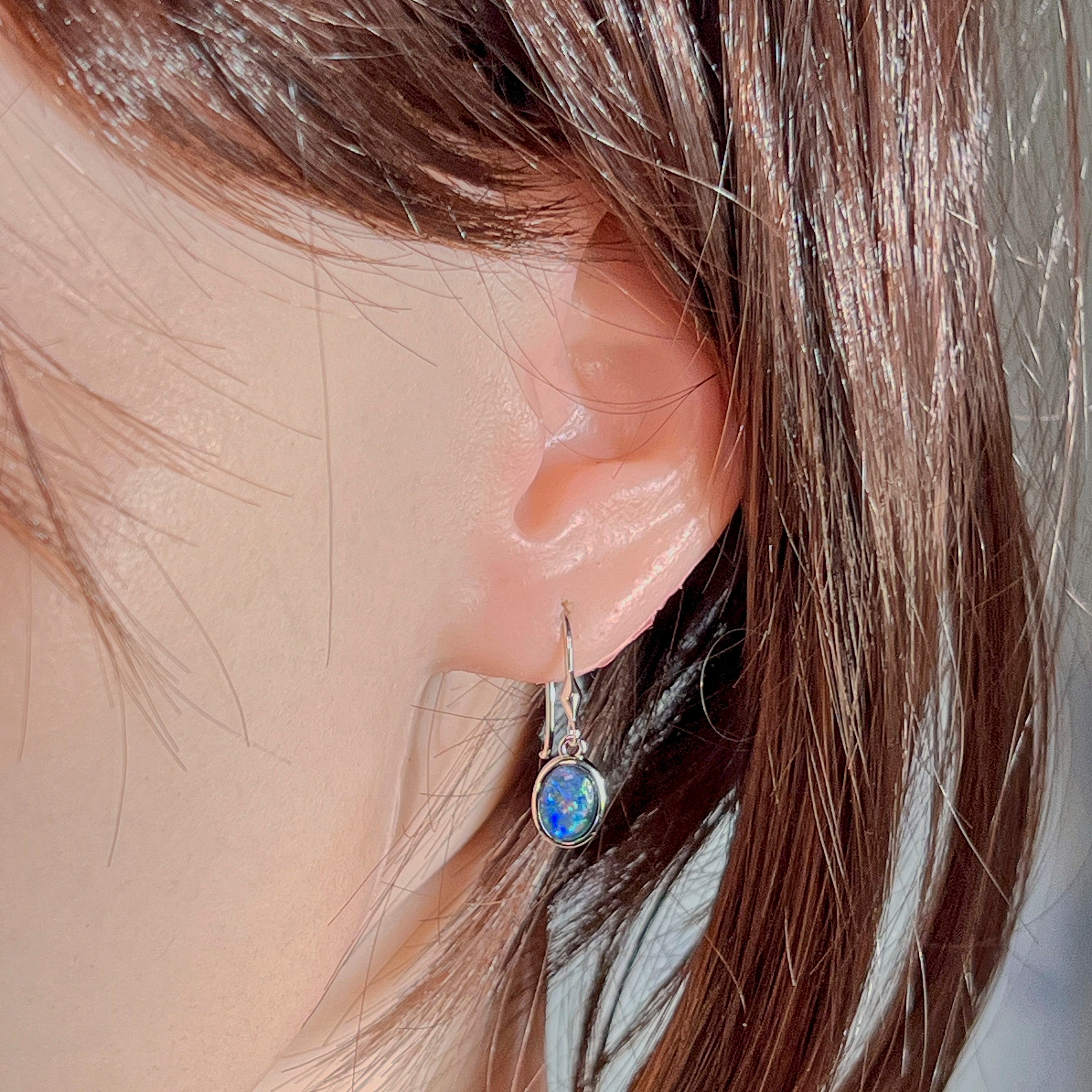 Worn close-up of the 8x6mm oval opal triplet earring in sterling silver