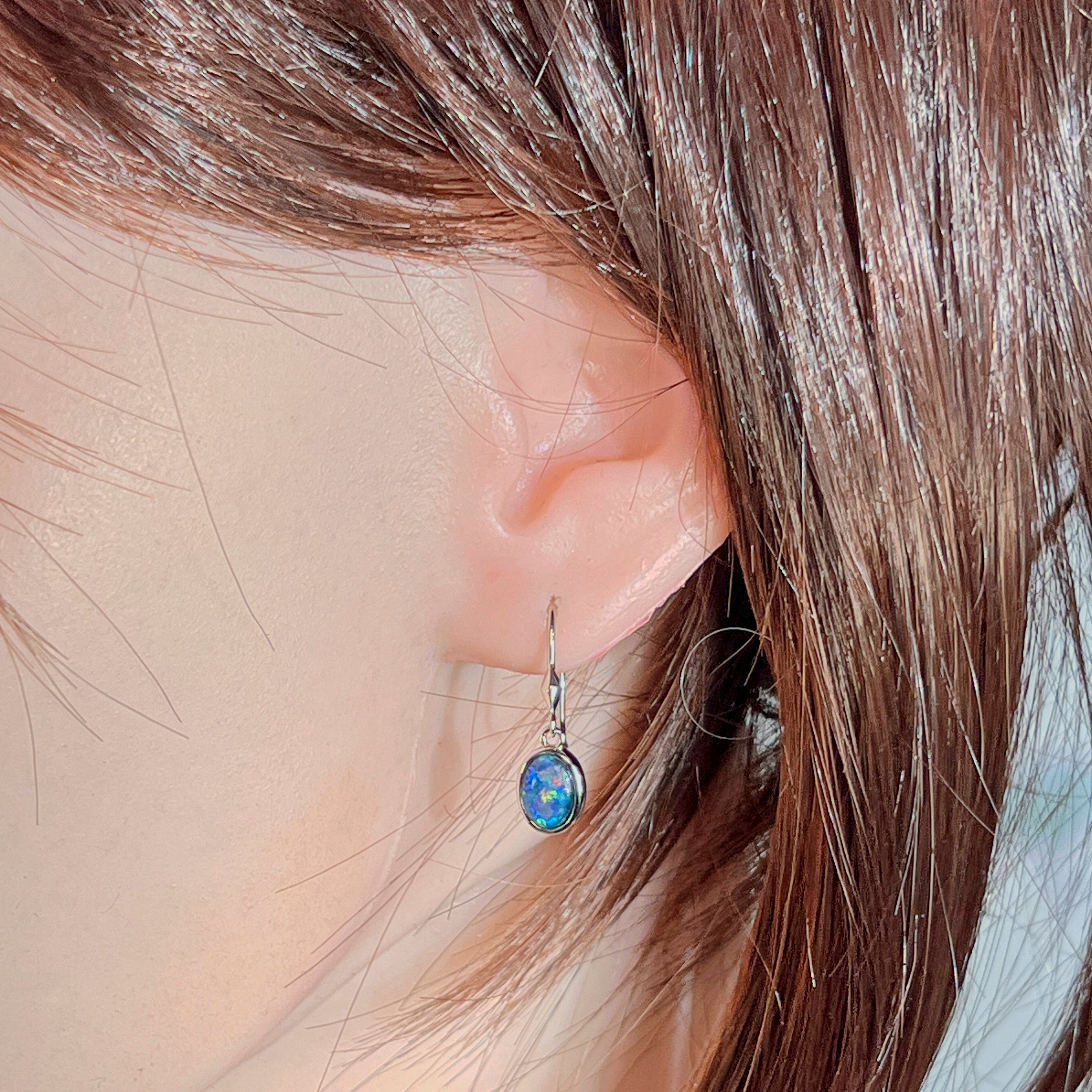 Model wearing the sterling silver opal triplet hook earring, showing drop length