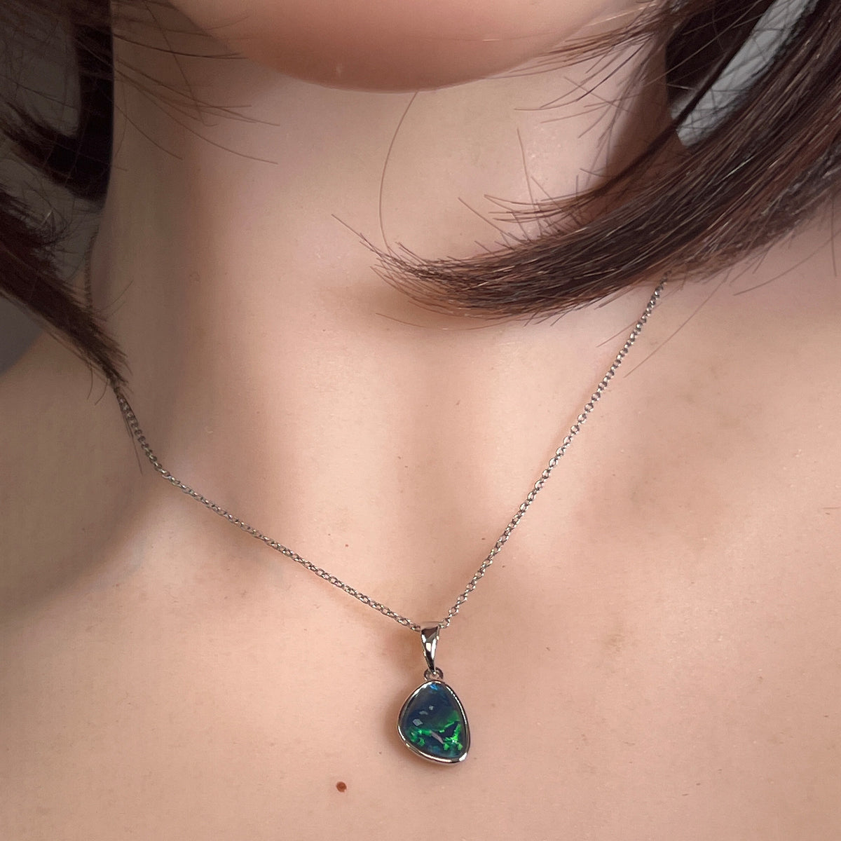 Worn Australian opal triplet pendant in sterling silver, blue and green, 12 x 9mm