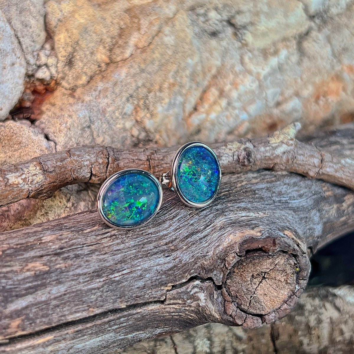 blue and green play-of-colour in 11 x 9mm oval Australian opal triplet earrings