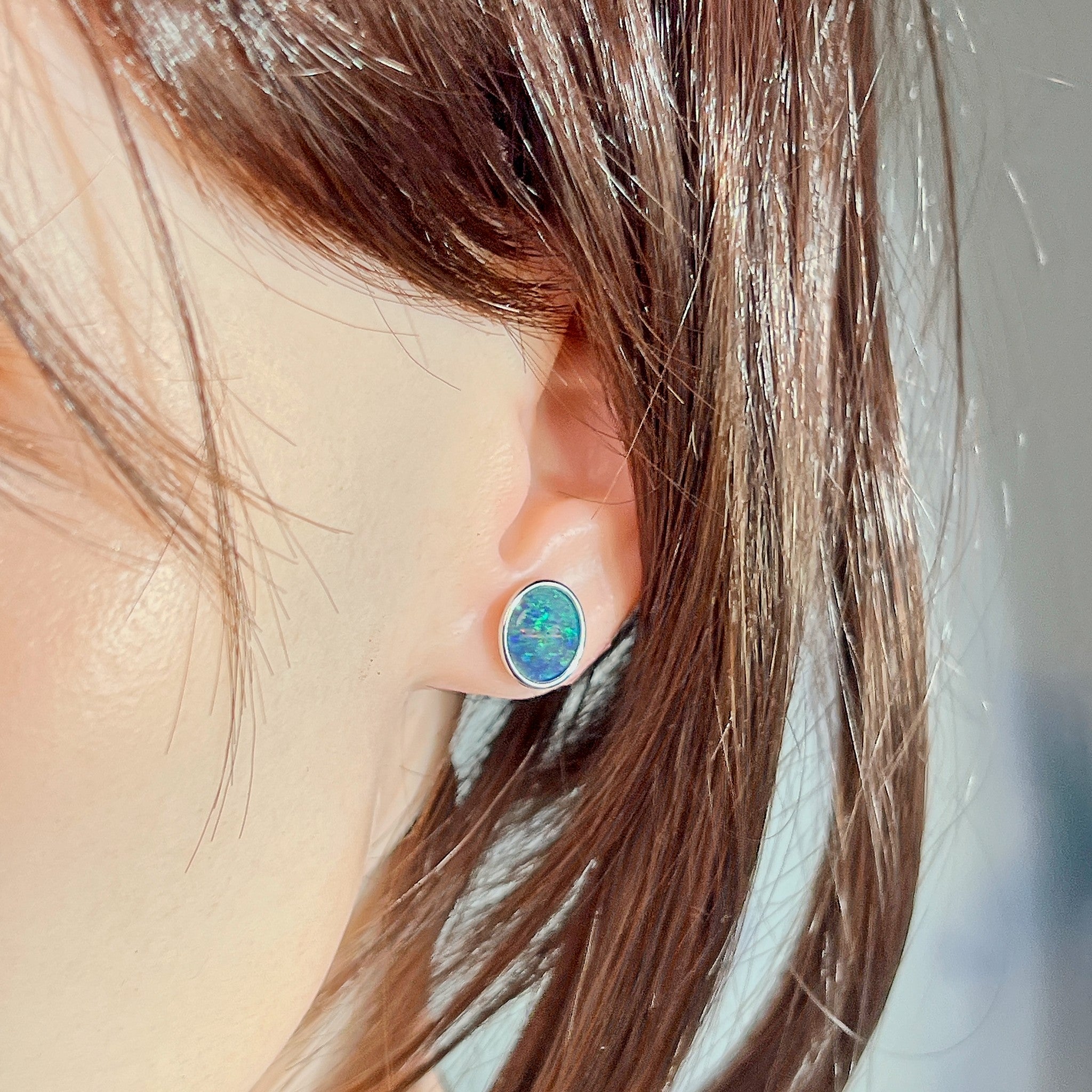 Worn Australian opal triplet earrings in sterling silver, blue and green, 11 x 9mm