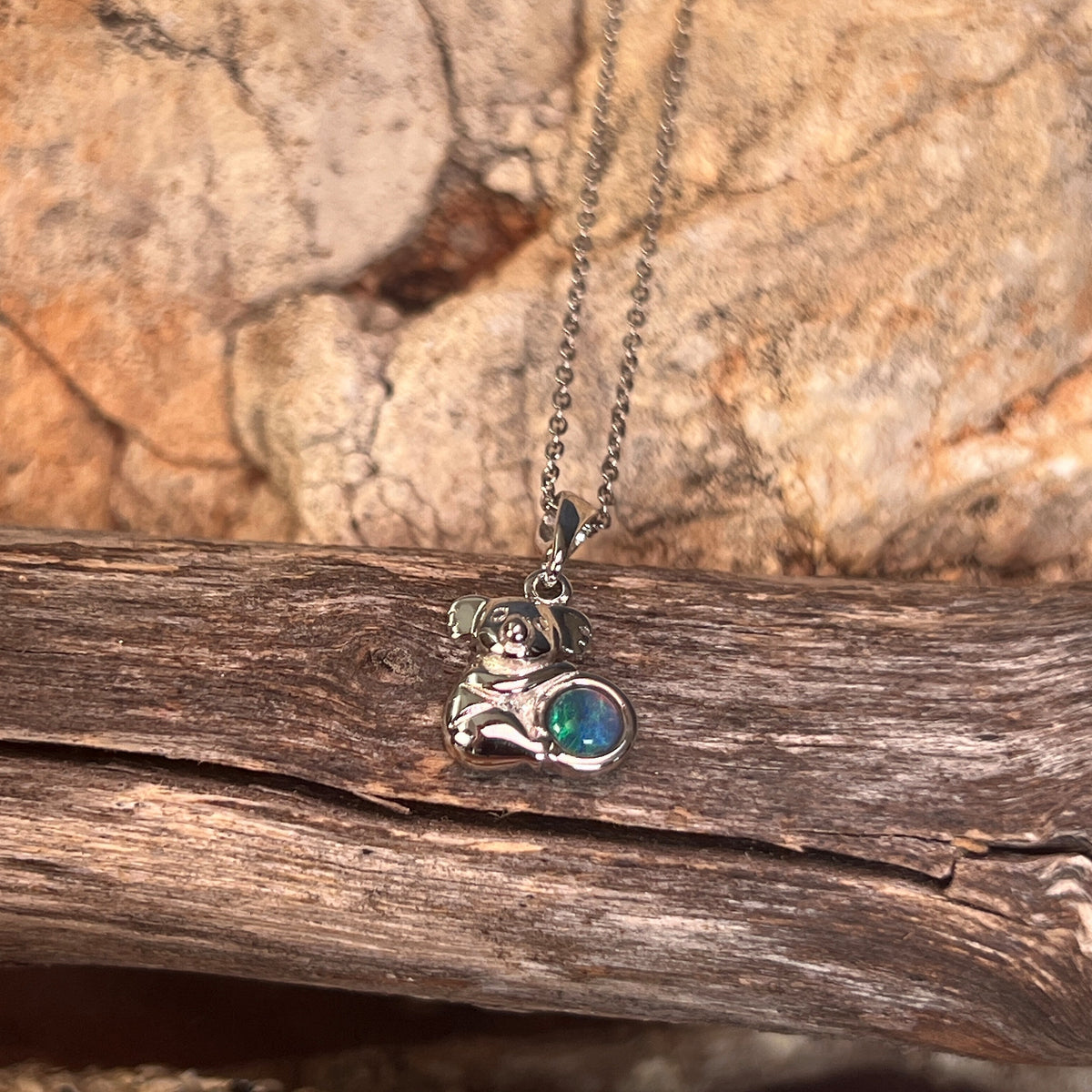 blue, green and yellow play-of-colour in a 5mm round Australian opal triplet pendant