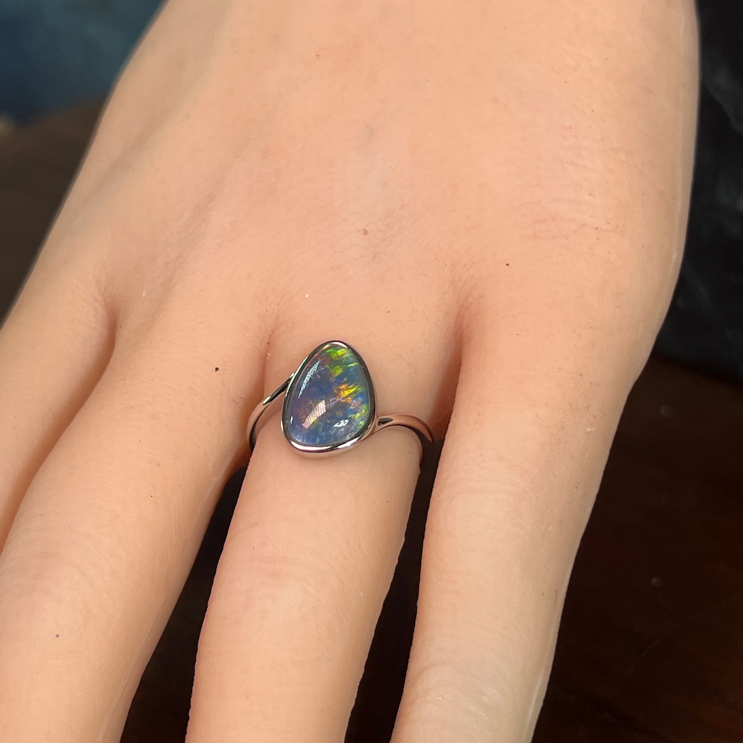 Australian opal triplet ring on the hand, sterling silver, 12 x 9mm triangular stone