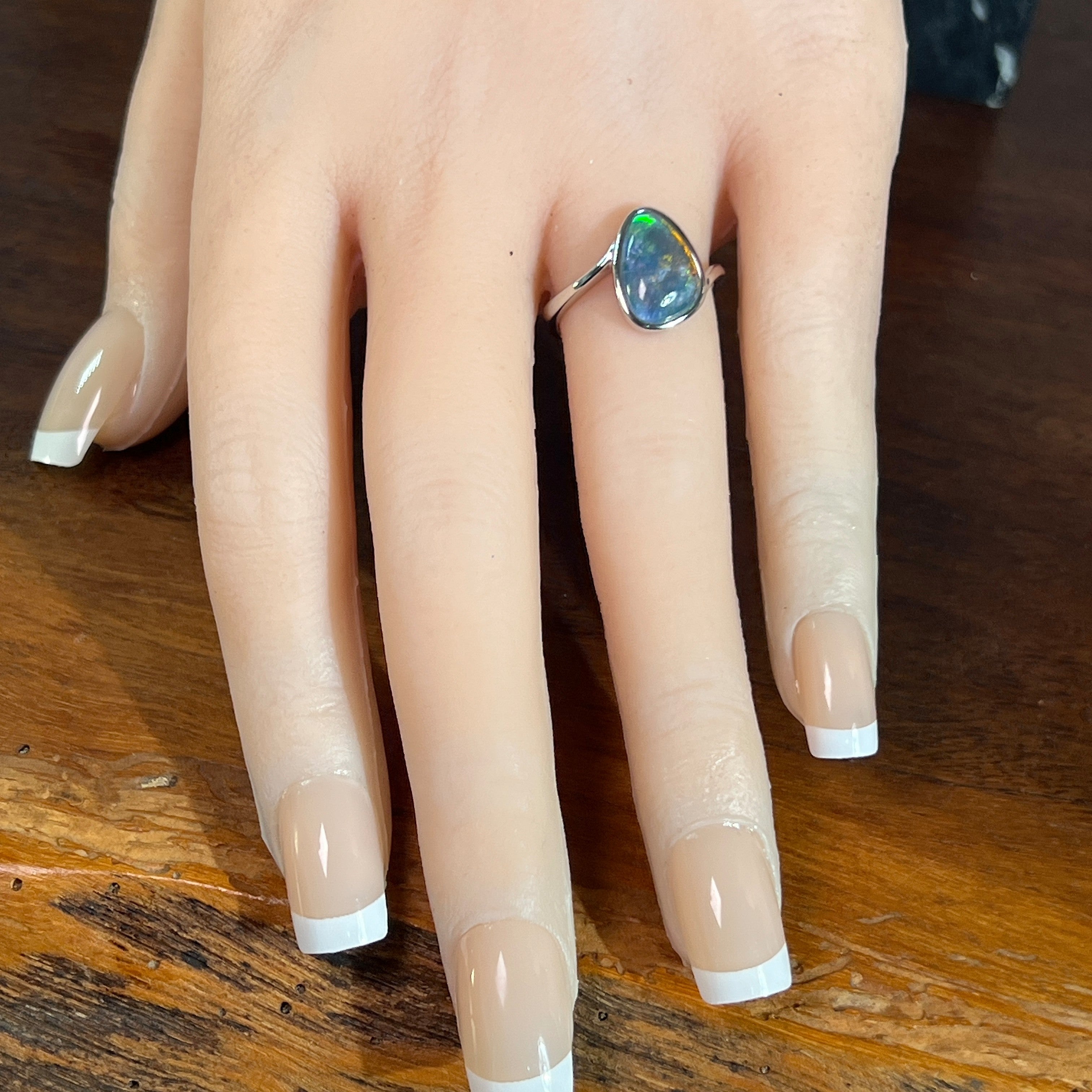 triangular Australian opal triplet ring worn, sterling silver, red, yellow, blue and green