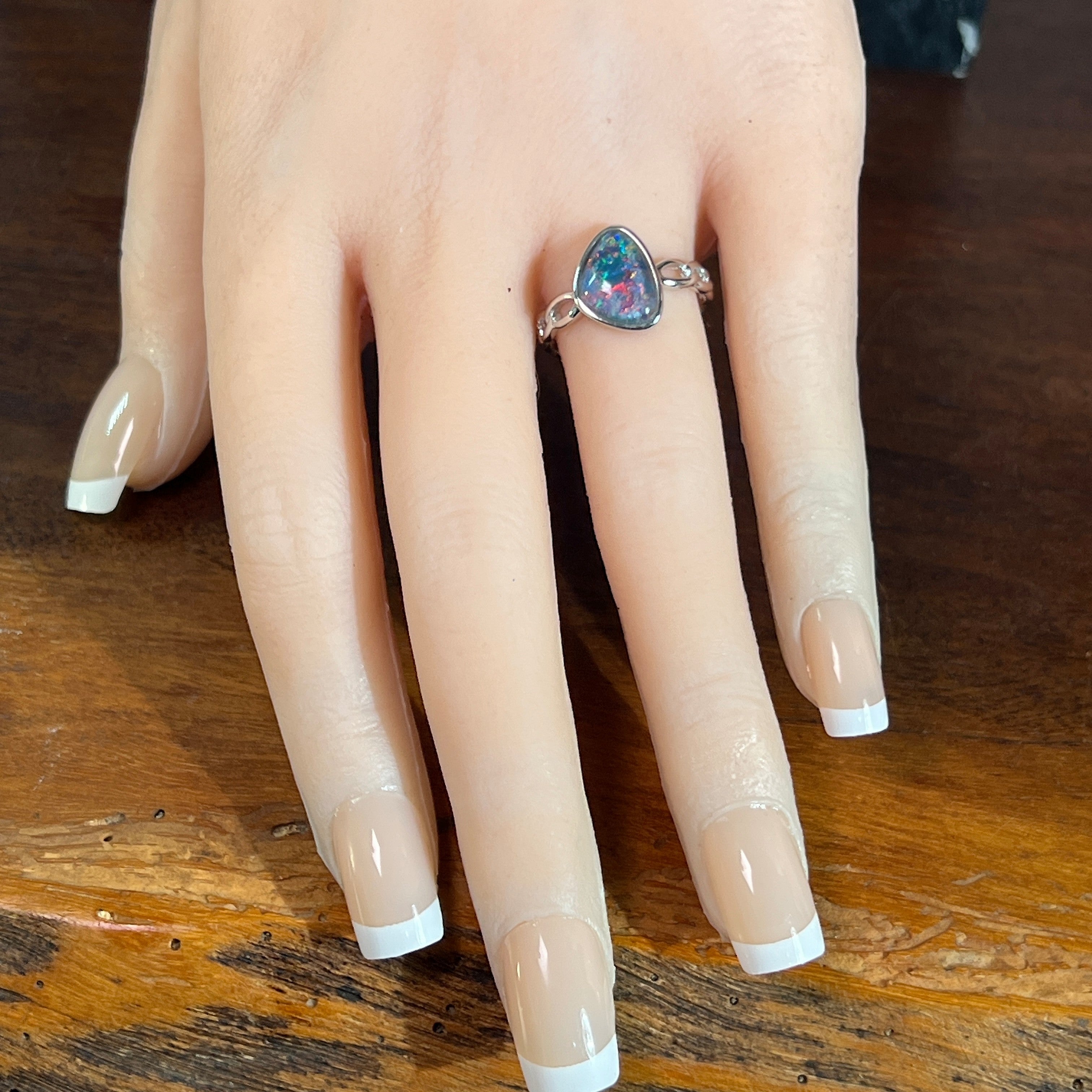 Australian opal triplet ring on the hand, sterling silver, 11 x 9mm triangular stone