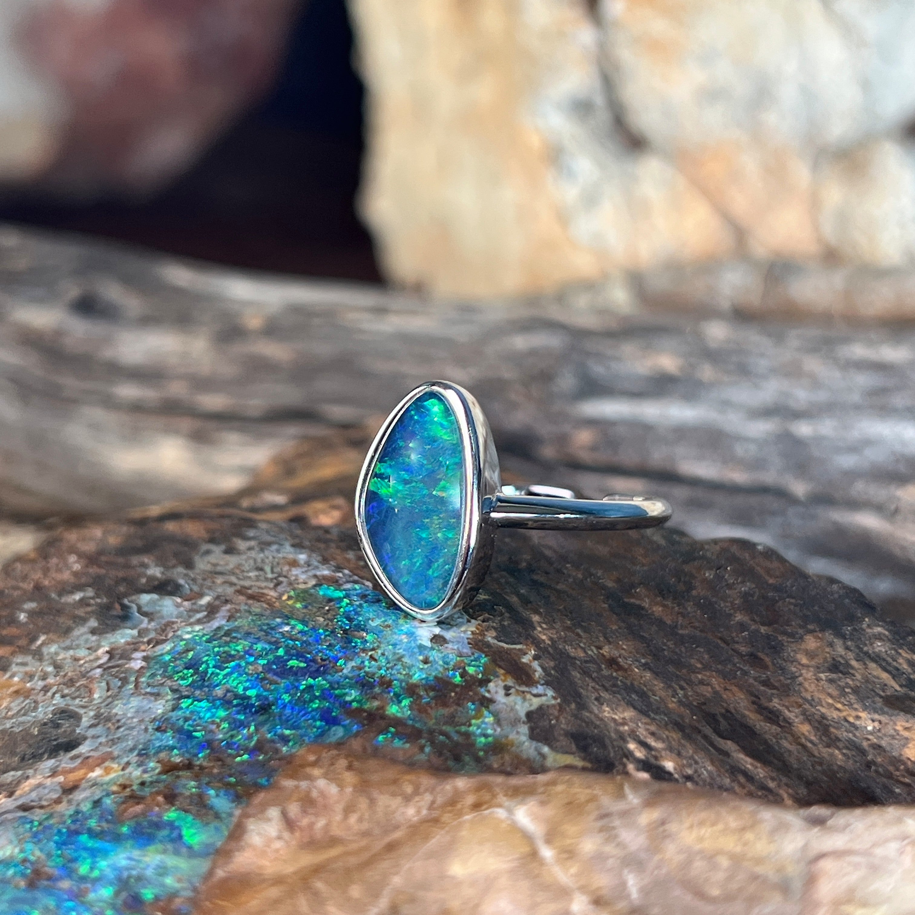 yellow, blue and green play-of-colour in a 14 x 8.5mm triangular Australian opal triplet ring