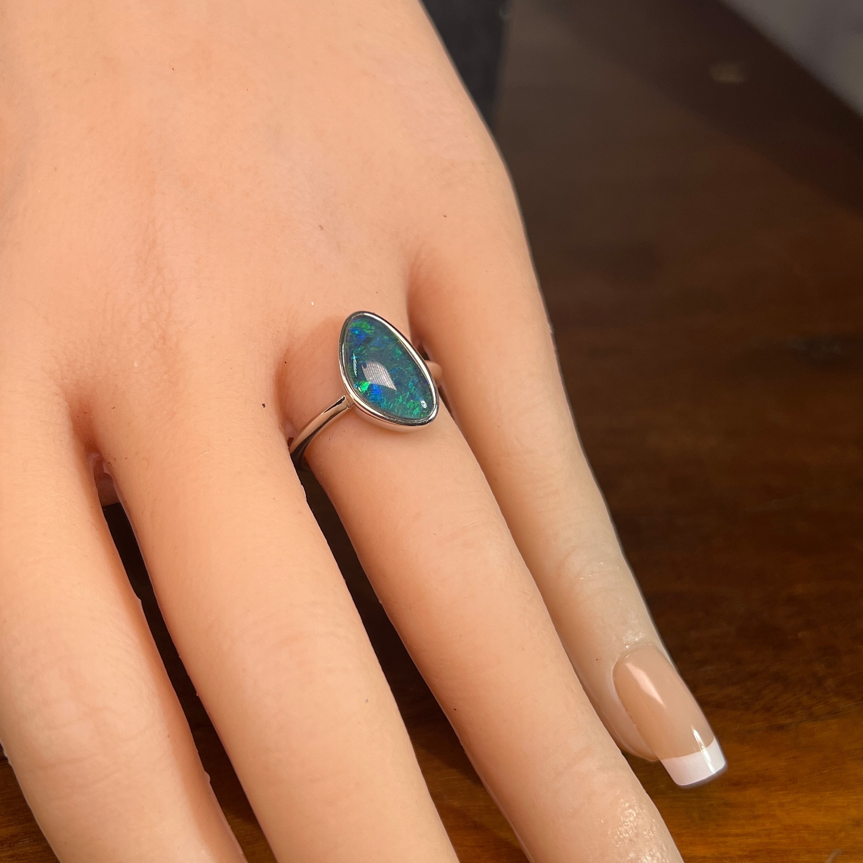14 x 8.5mm triangular Australian opal triplet ring on the hand, sterling silver
