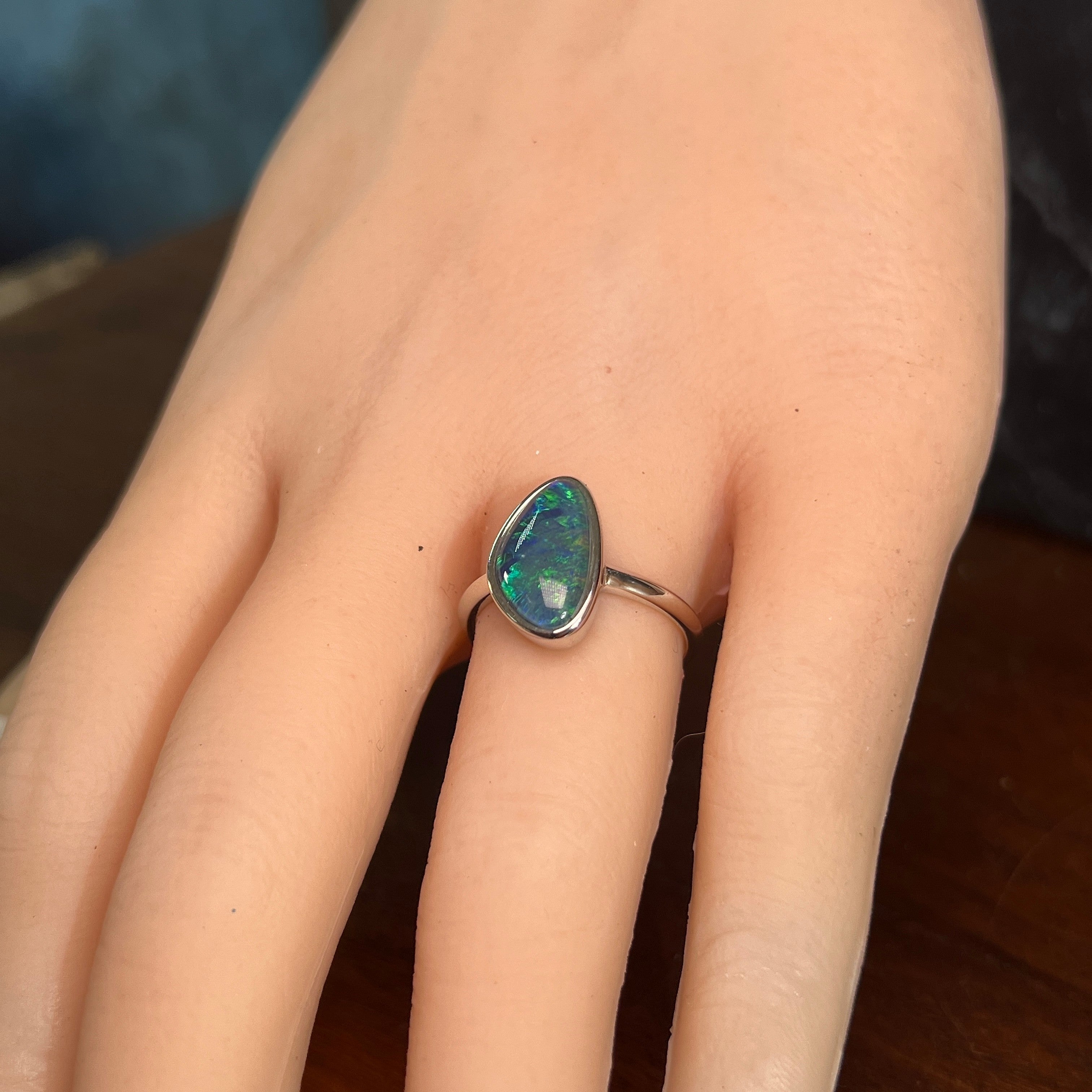 triangular Australian opal triplet ring worn, sterling silver, yellow, blue and green