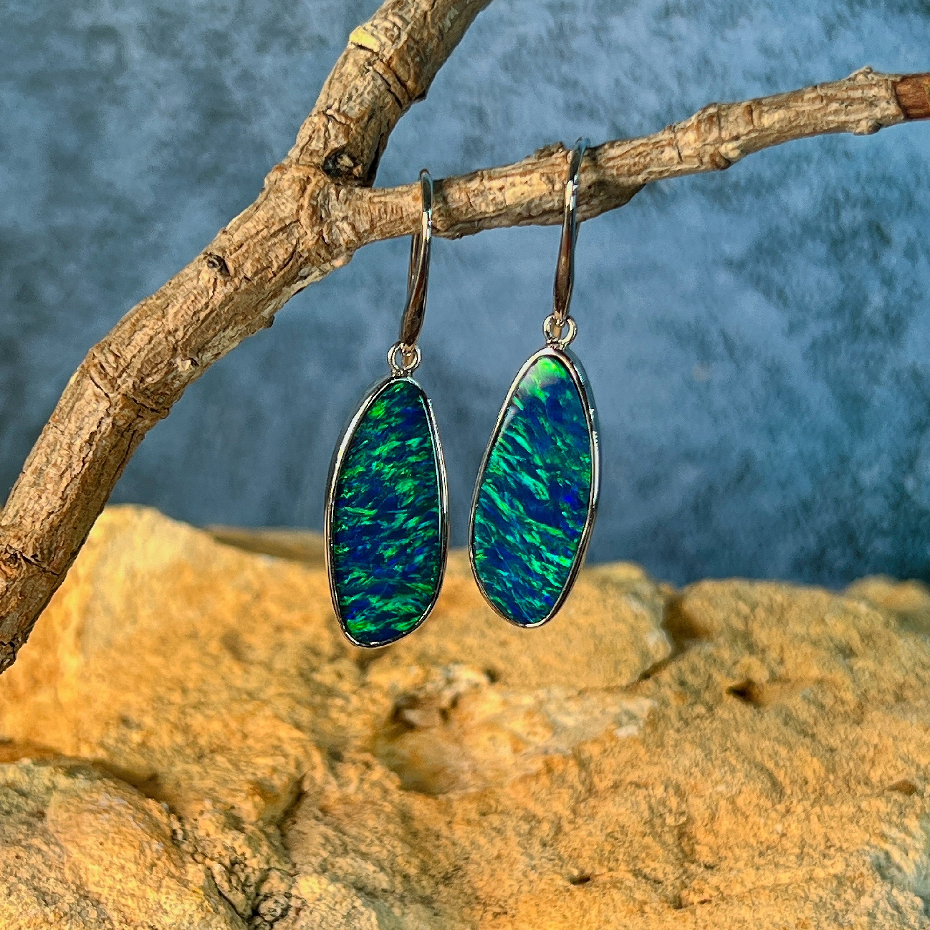 Freeform opal doublet drops on white gold hooks, showing the elongated oval stones